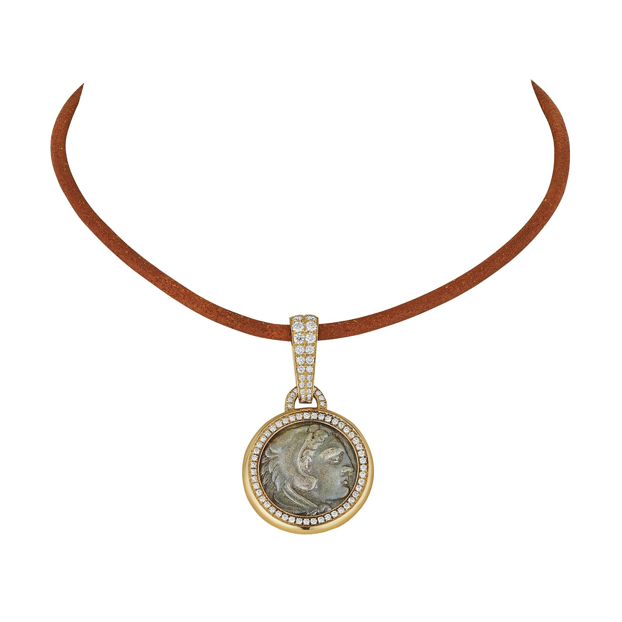 Wear a piece of the past with this Bulgari vintage diamond ancient silver coin gold collar necklace.  With a diamond framed ancient coin, circa 336-323 b.c., hanging from an original milk chocolate brown leather cord, this collar reflects a