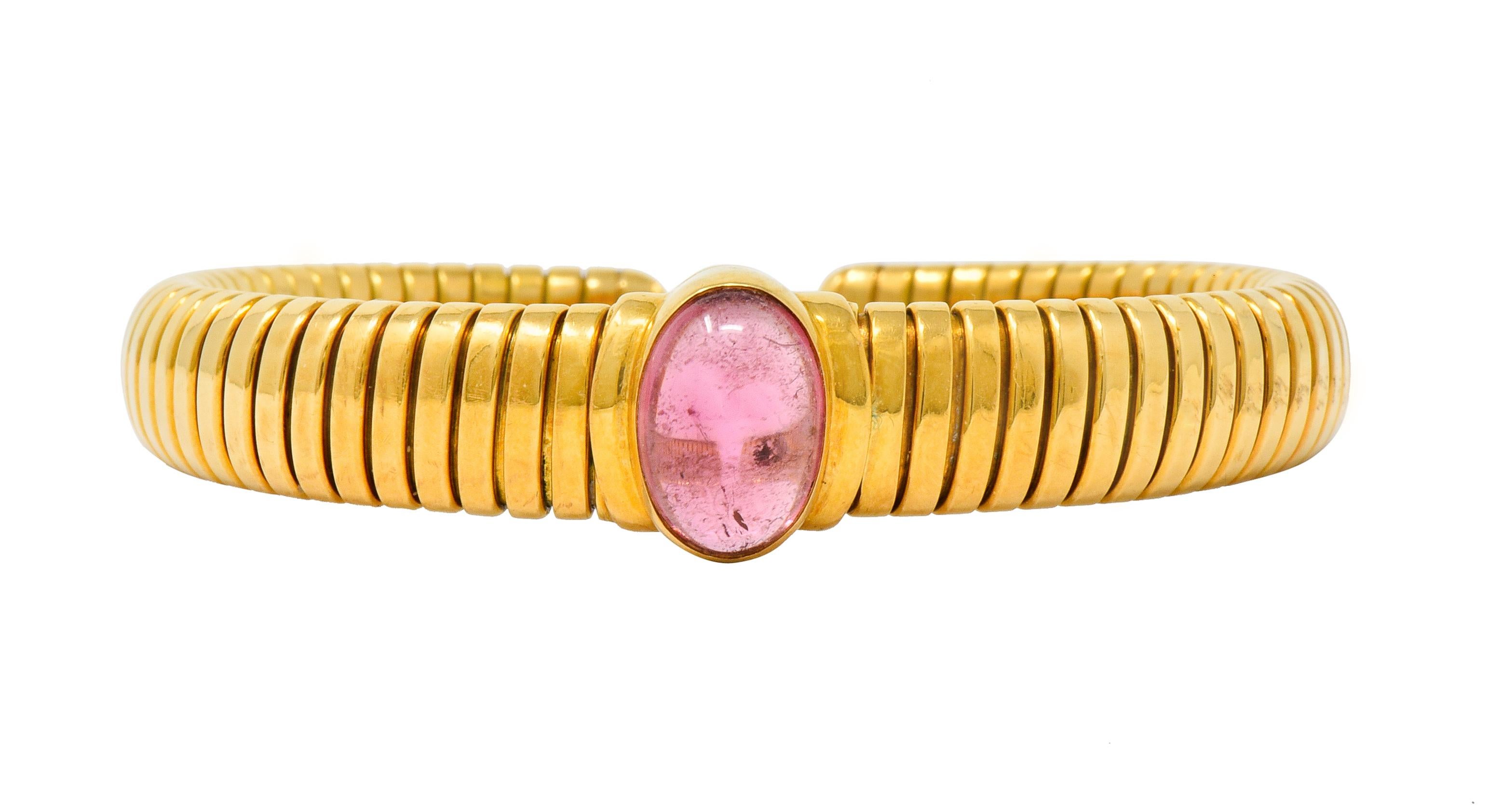 Cuff style bracelet designed with iconic tubogas technology, deeply ribbed with a flexible fit

Centering a bezel set oval tourmaline cabochon measuring approximately 12.0 x 8.5 mm

A very saturated pink color, transparent with some natural