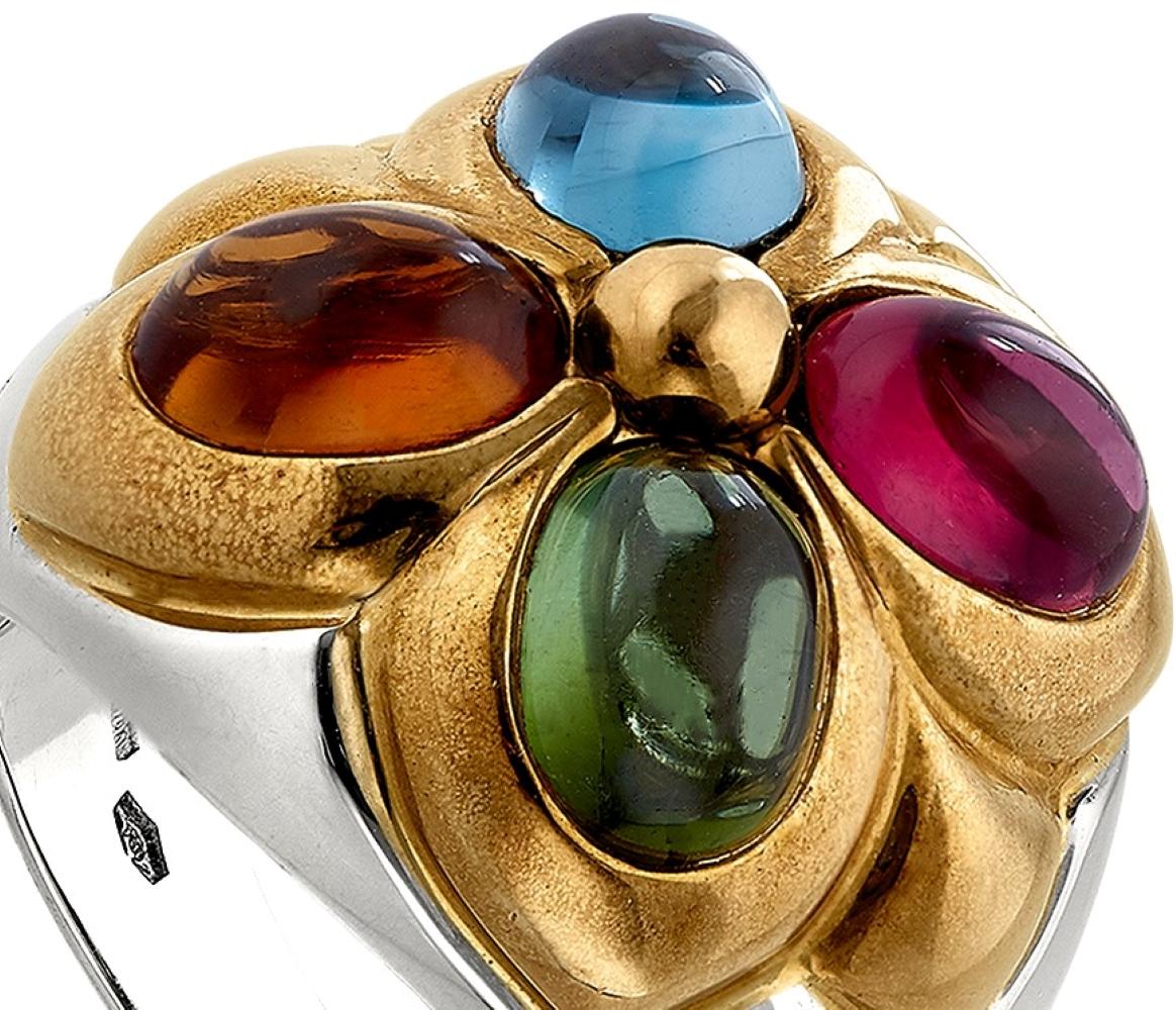 This is a beautiful multi color ring by Bulgari. It features a Cabochon Tourmaline and Aquamarine along with 2 cabochon Citrines set 18 karat white and yellow gold.

Classic and cool, this multicolored ring is sure to grab attention. Multi stoned