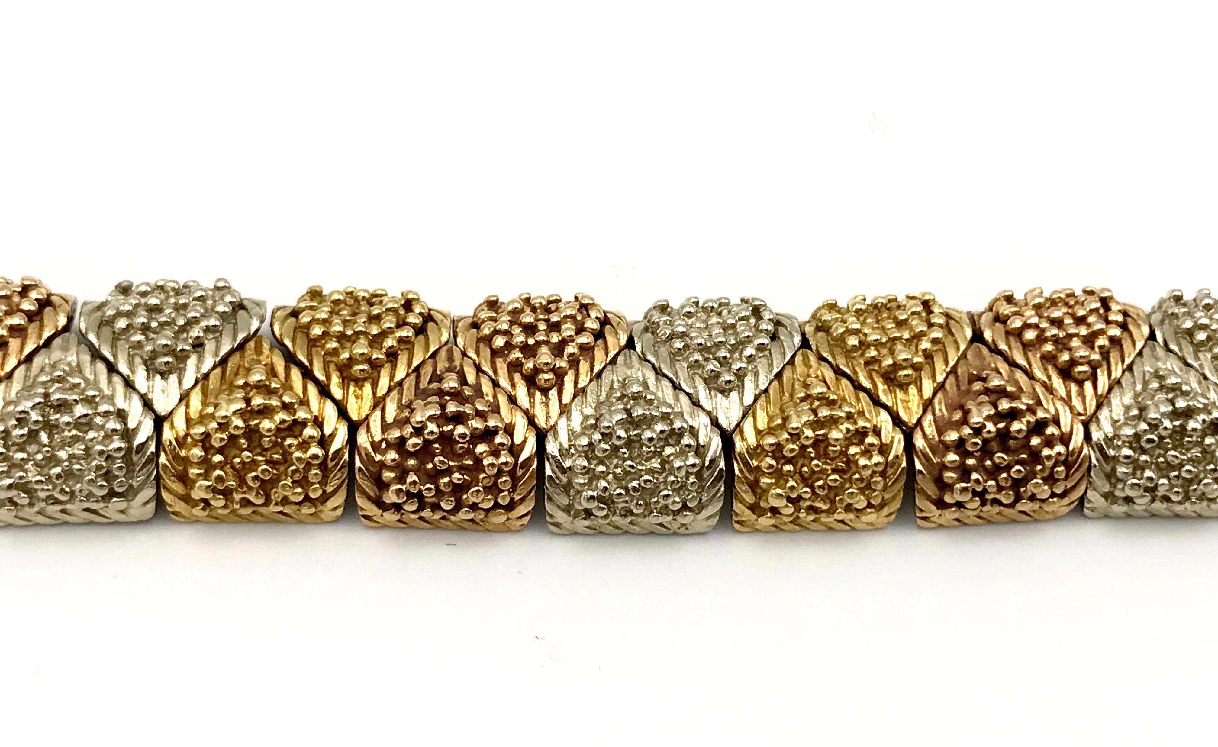 Vintage (c.1970s) Bulgari bracelet made of textured 18k yellow, white and rose gold. Features the connected sections that make the bracelet flexible. Stamped with Bulgari maker's mark and a hallmark for 18k gold.
Measurements: 7.25
