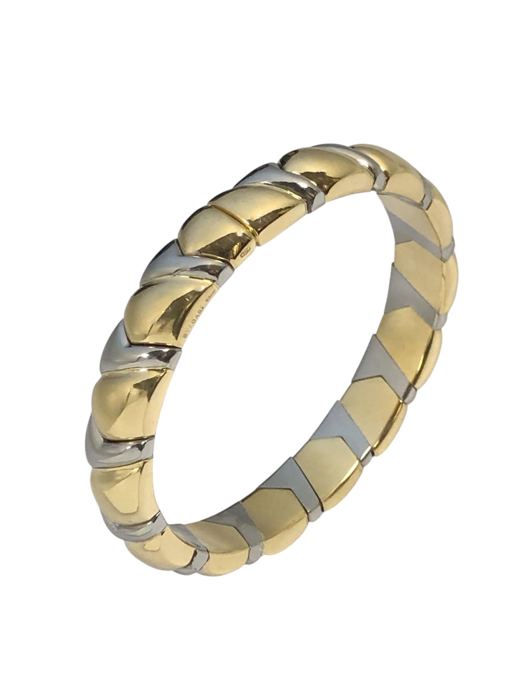 Circa 1980s Bulgari 18k White and Yellow Gold Bangle Bracelet, measuring 9.5 M.M. ( 3/8 ) inch wide and weighing 40 Grams, solid, heavy flexible construction with an inside measurement of 6 1/2 inches and with the flexible opening will fit a 7 inch