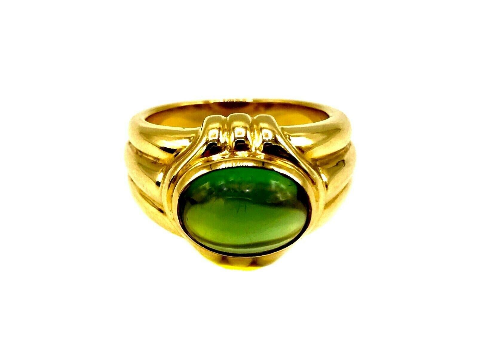 Vintage Bulgari ring made of 18k yellow gold featuring cabochon cut peridot. Stamped with the Bulgari maker's mark and a hallmark for 18k gold. 
Measurements: the ring size is 6.75 (sizable). Height is 1/2