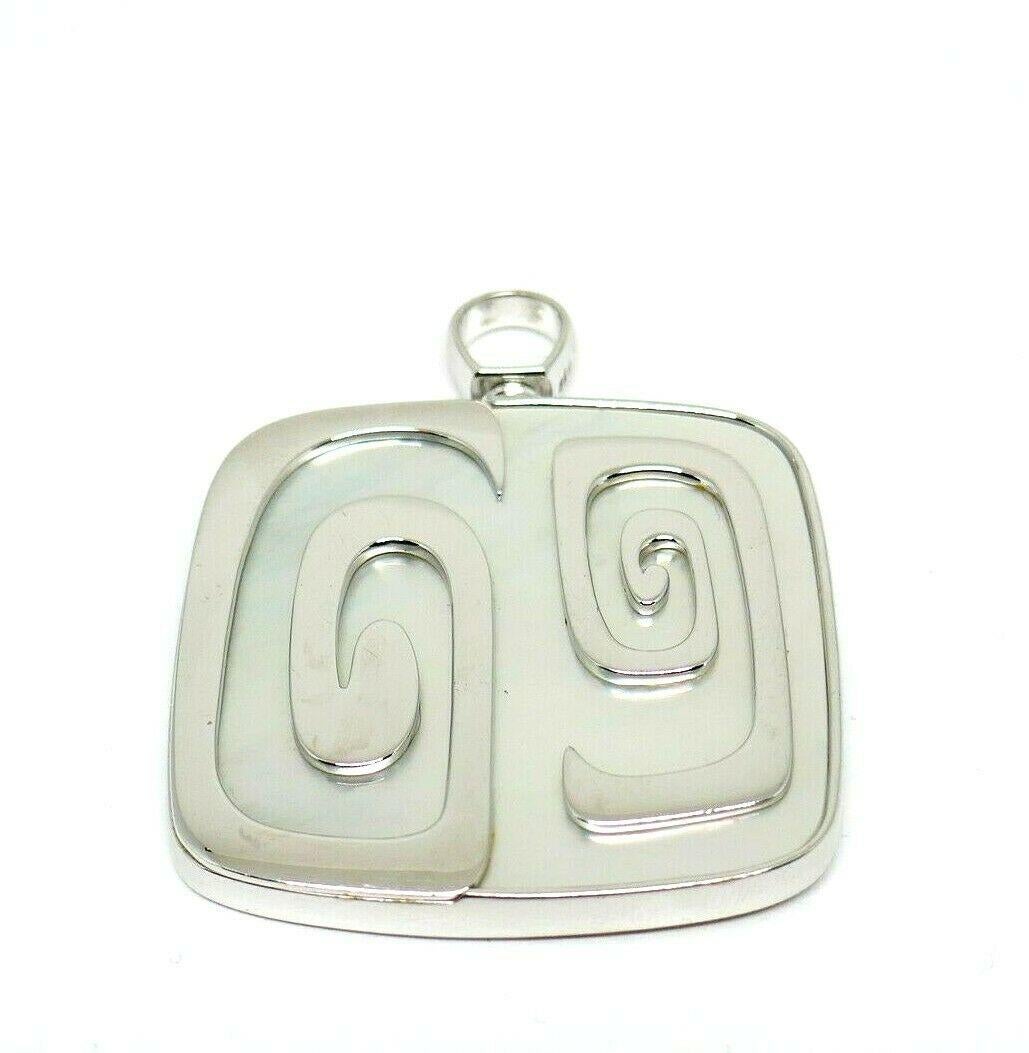 Rare 18k white gold and Mother of Pearl pendant from the limited Bulgari Theme Collection (circa 2003). 
Stamped with the Bulgari maker's mark, a hallmark for 18k gold, a serial number and a country of origin (Italy).
Measurements: 1 3/4