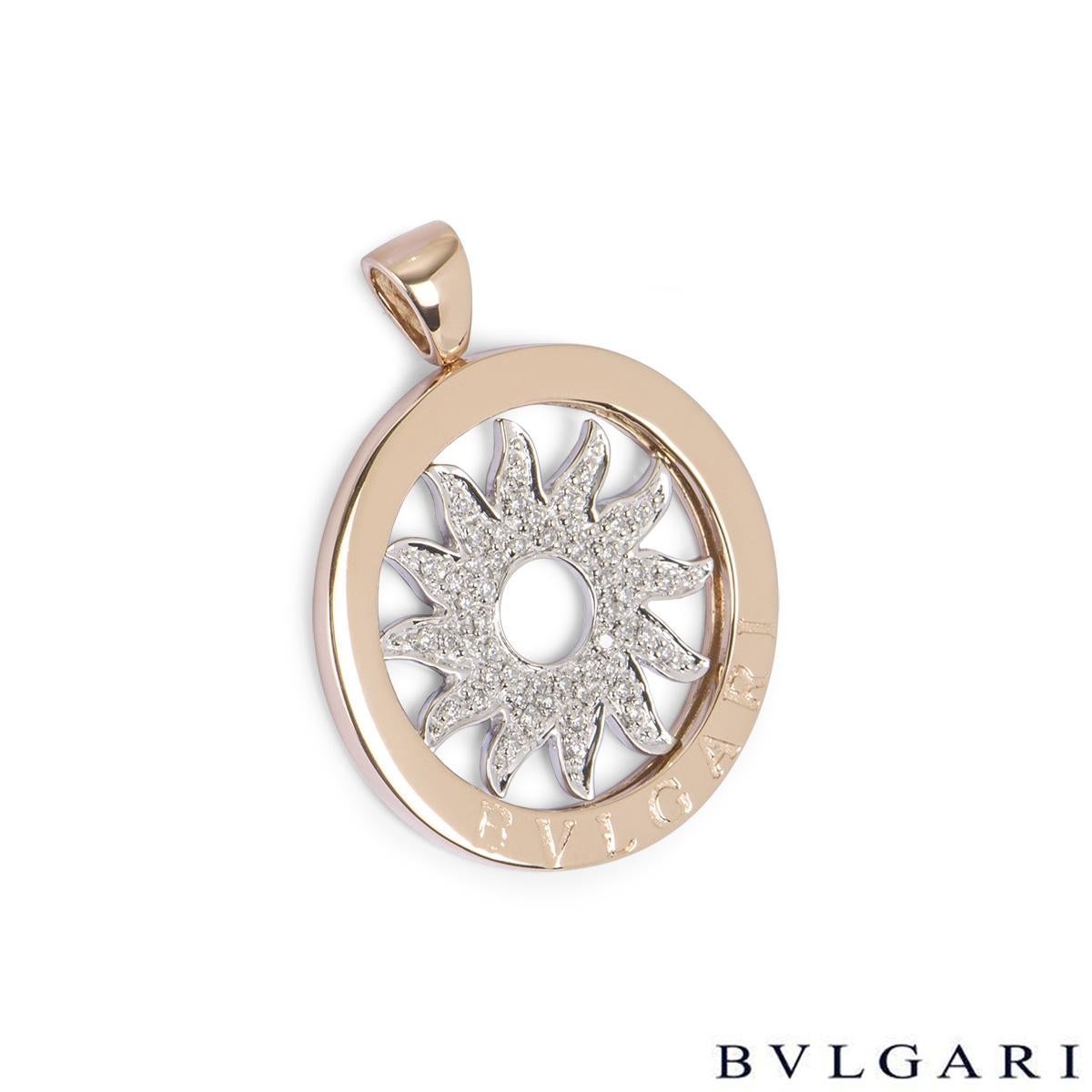 An 18k white and rose gold pendant from the Tondo collection by Bvlgari. The pendant features a diamond set spinning sun motif in the centre with a rose gold boarder displaying the Bvlgari logo. The pendant measures 2.7cm in diameter and has a gross
