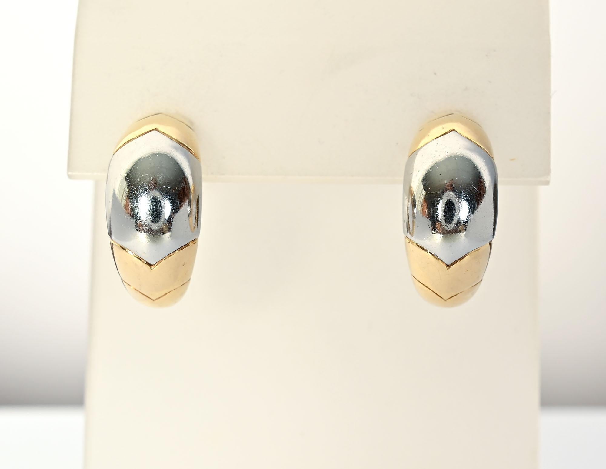 Tailored half hoop earrings by Bulgari. Top and bottom are yellow gold with white in the center. The earrings have the curved V design often used by Bulgari. The earrings are half an inch wide and three quarters of an inch long. These earrings are