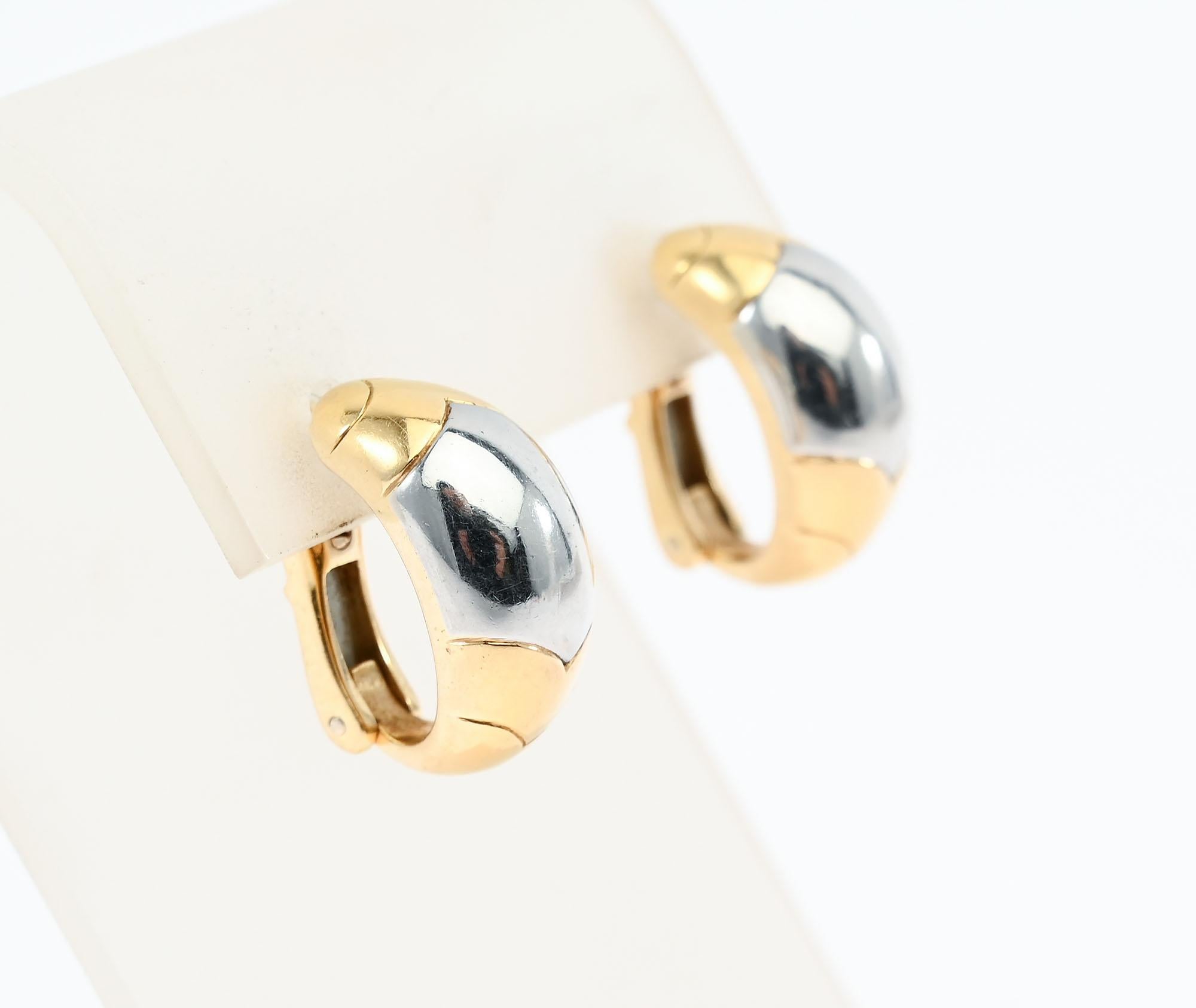 Tailored half hoop earrings by Bulgari. Top and bottom are yellow gold with white in the center. The earrings have the curved V design often used by Bulgari. The earrings are half an inch wide and three quarters of an inch long. These earrings are