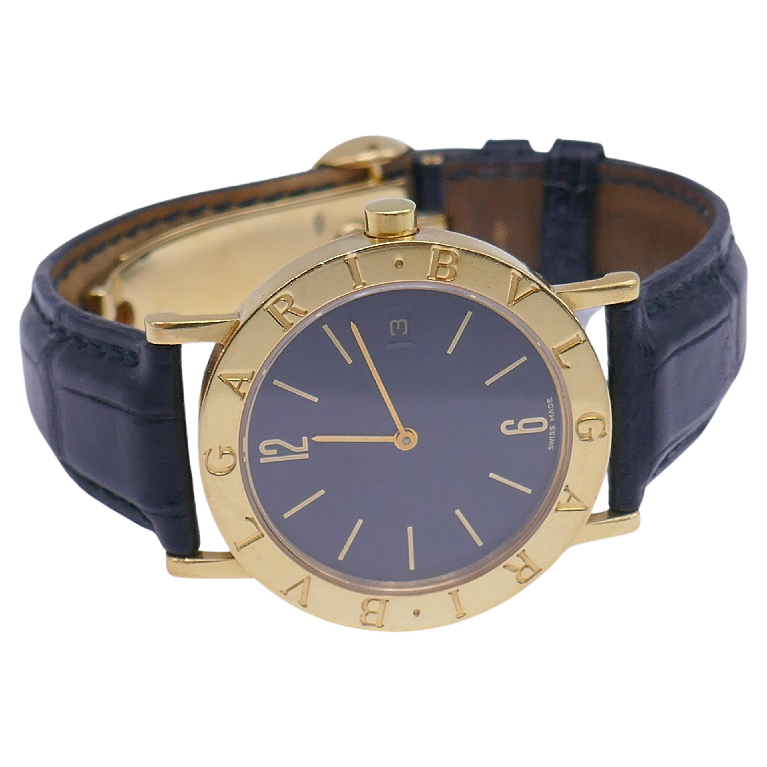 A classic Bulgari BB33 unisex wristwatch made of 18k yellow gold. Features a leather strap with a deployment buckle. Has a Swiss quartz movement. Stamped with Bulgari maker's mark, a model and serial number and a country of origin (Switzerland). The