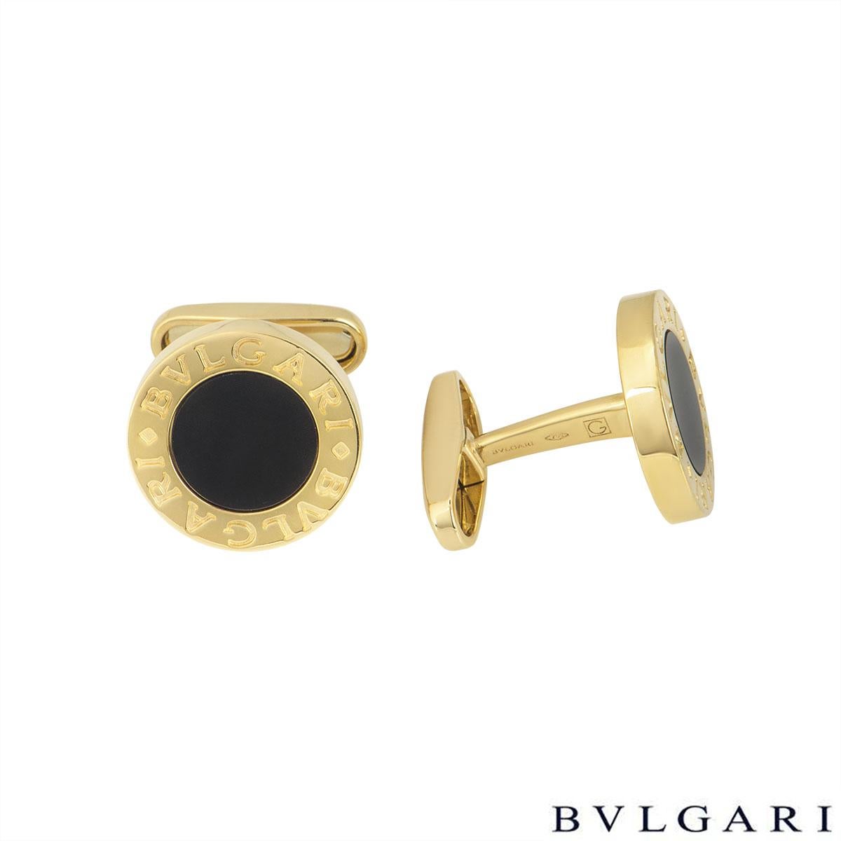 A pair of 18k yellow gold and onyx cufflinks by Bvlgari from the Bvlgari Bvlgari collection. The cufflinks comprise of a round onyx table featuring the iconic Bvlgari Bvlgari motif set to an 18k yellow gold border. The cufflinks are finished with