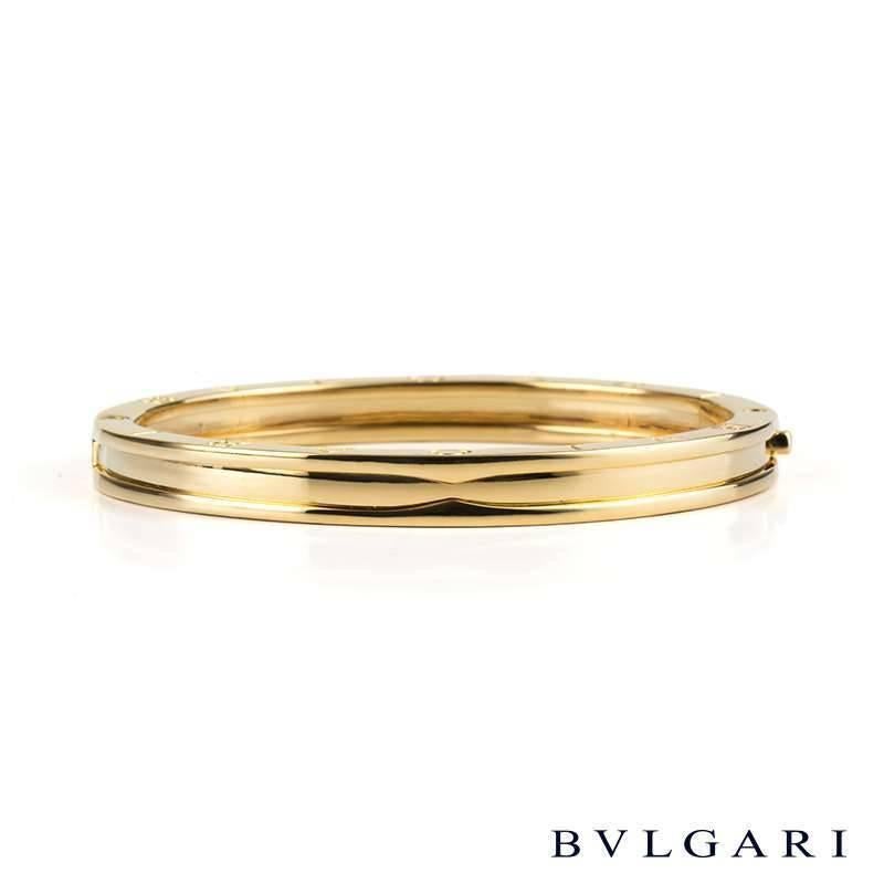 A stylish 18k yellow gold Bvlgari bangle from the B.Zero1 collection. The bangle comprises of the Bvlgari motif embossed on the outer edges of the bangle. The bangle features a box clasp and measures 7mm in width and fits a wrist size of up to 7.5