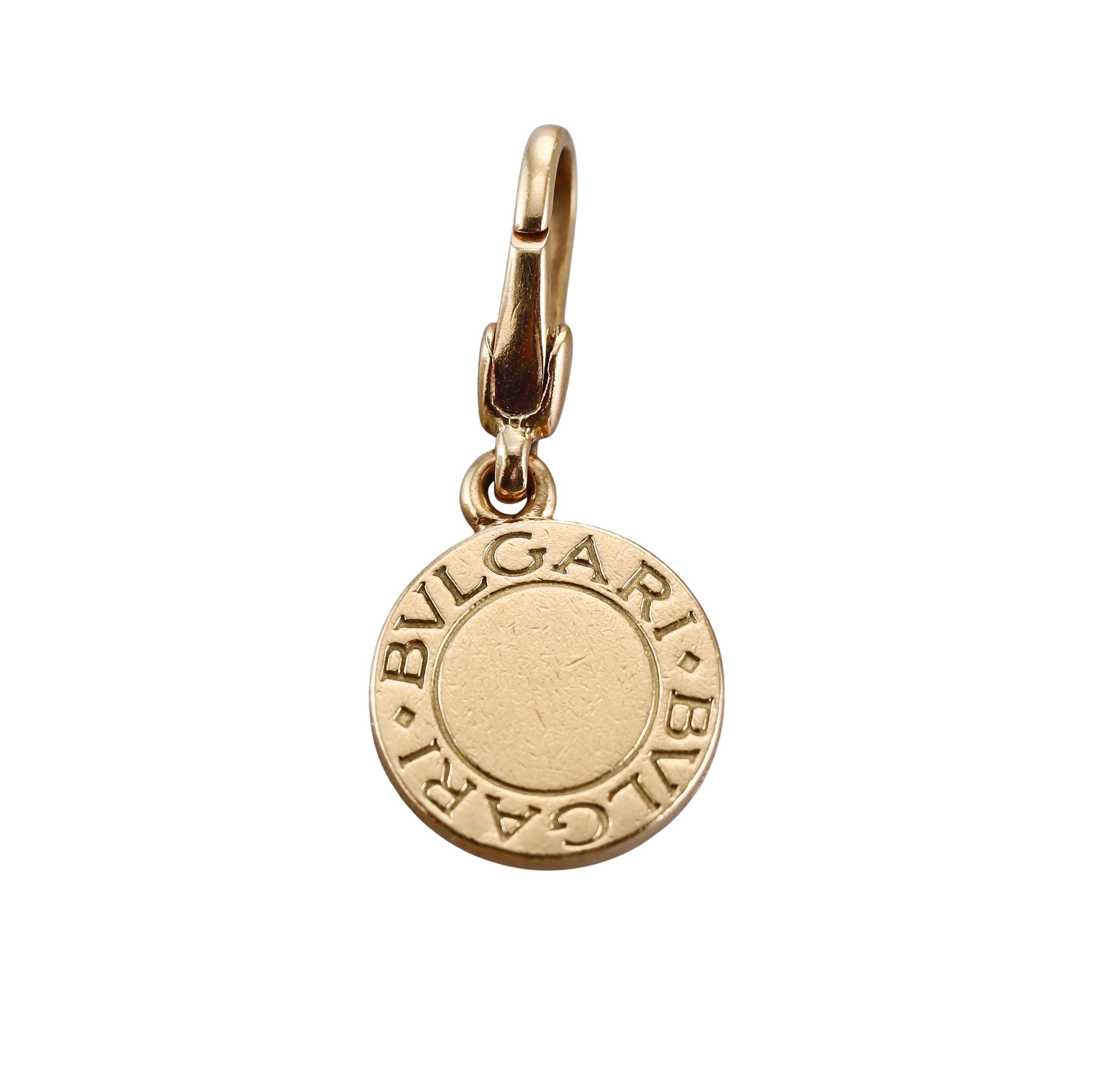 An 18k yellow gold charm pendant by Bvlgari with coral. Pendant is 28mm long with bale and is 13mm in diameter. Marked Bvlgari, made in Italy, 750. Weight - 3.9 grams. 