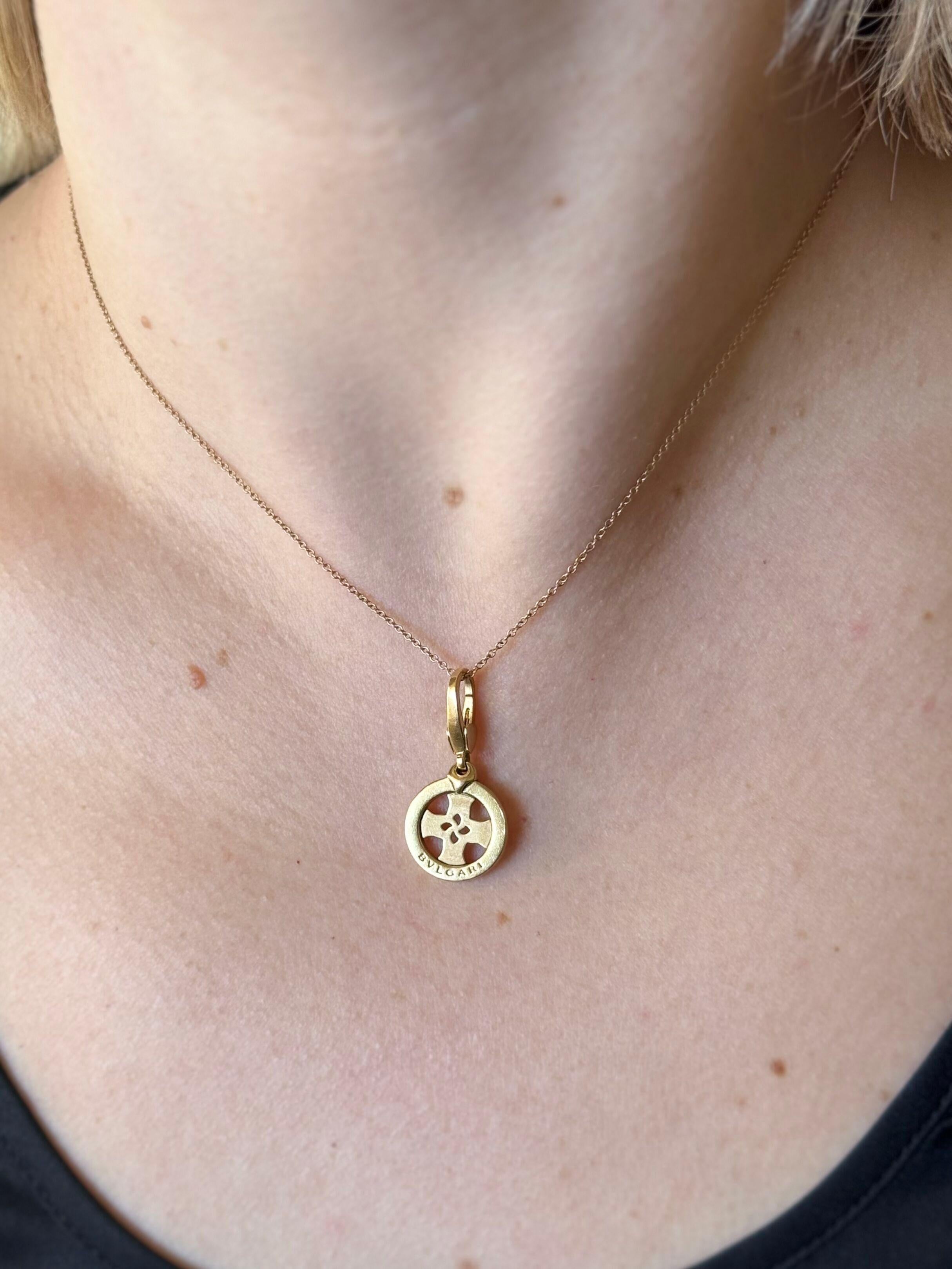 An 18k yellow gold cross pendant charm by Bvlgari, suspended on a Tiffany & Co classic chain. Necklace is 16