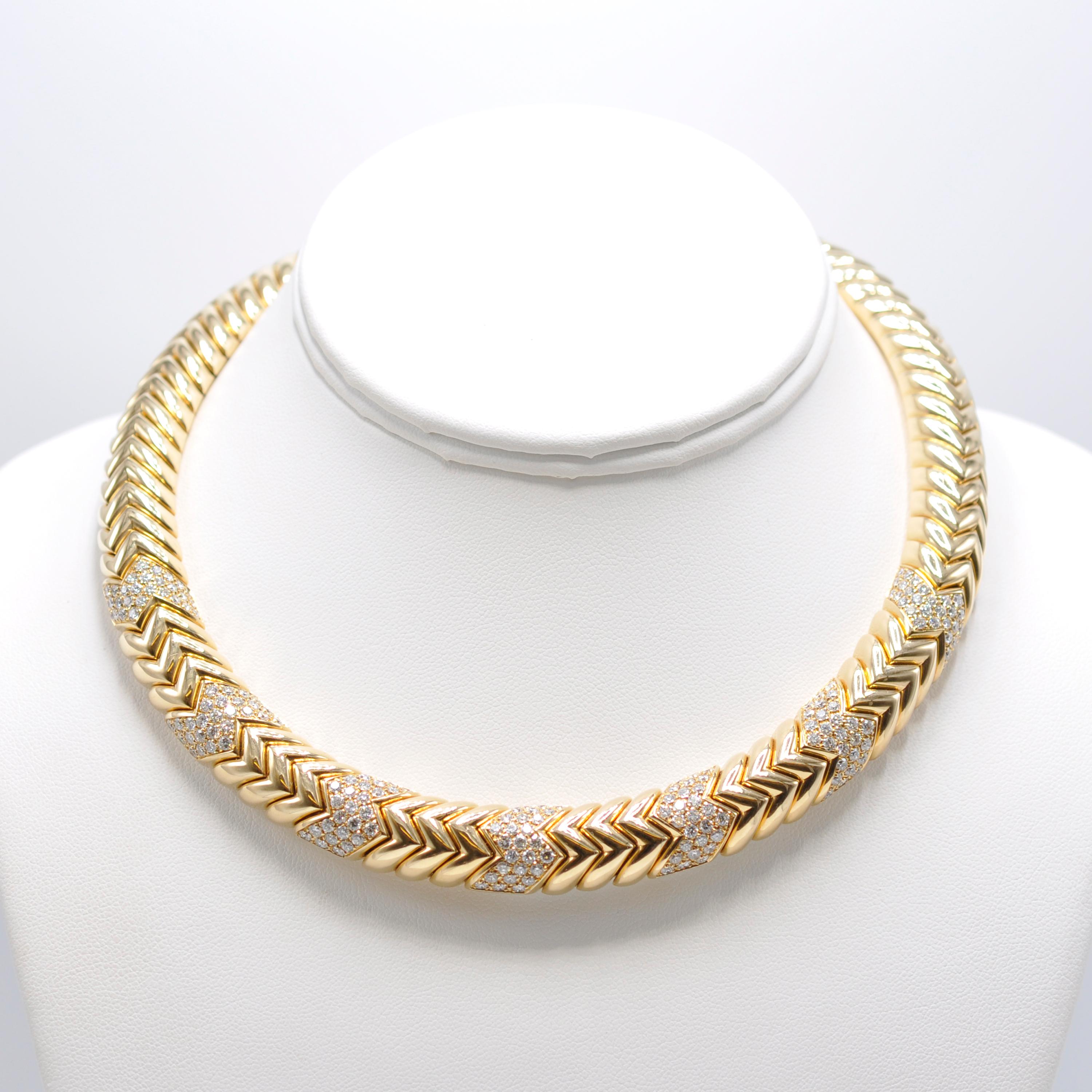 Impressive Italian 18 Karat yellow gold Diamond Bulgari Spiga Collar Necklace is sure to make a statement where ever you go. 

The links of this necklace sit together in a chevron pattern which is mimicked by the 7 evenly spaced diamond stations