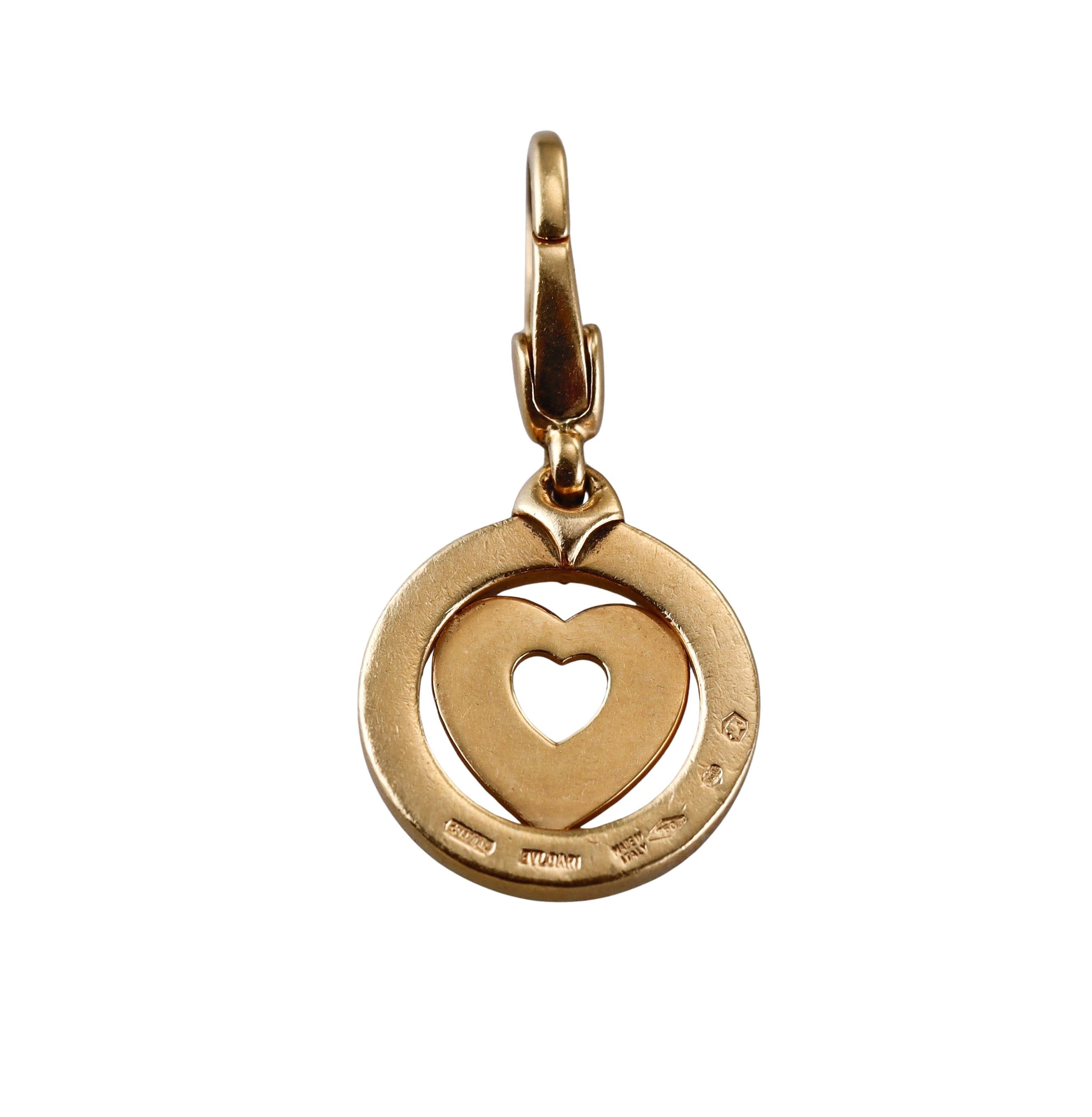 An 18k yellow gold charm pendant by Bvlgari depicting a heart. Pendant is 28mm long with bale and is 13mm in diameter. Marked Bvlgari, made in Italy, 750. Weight - 3.9 grams. 