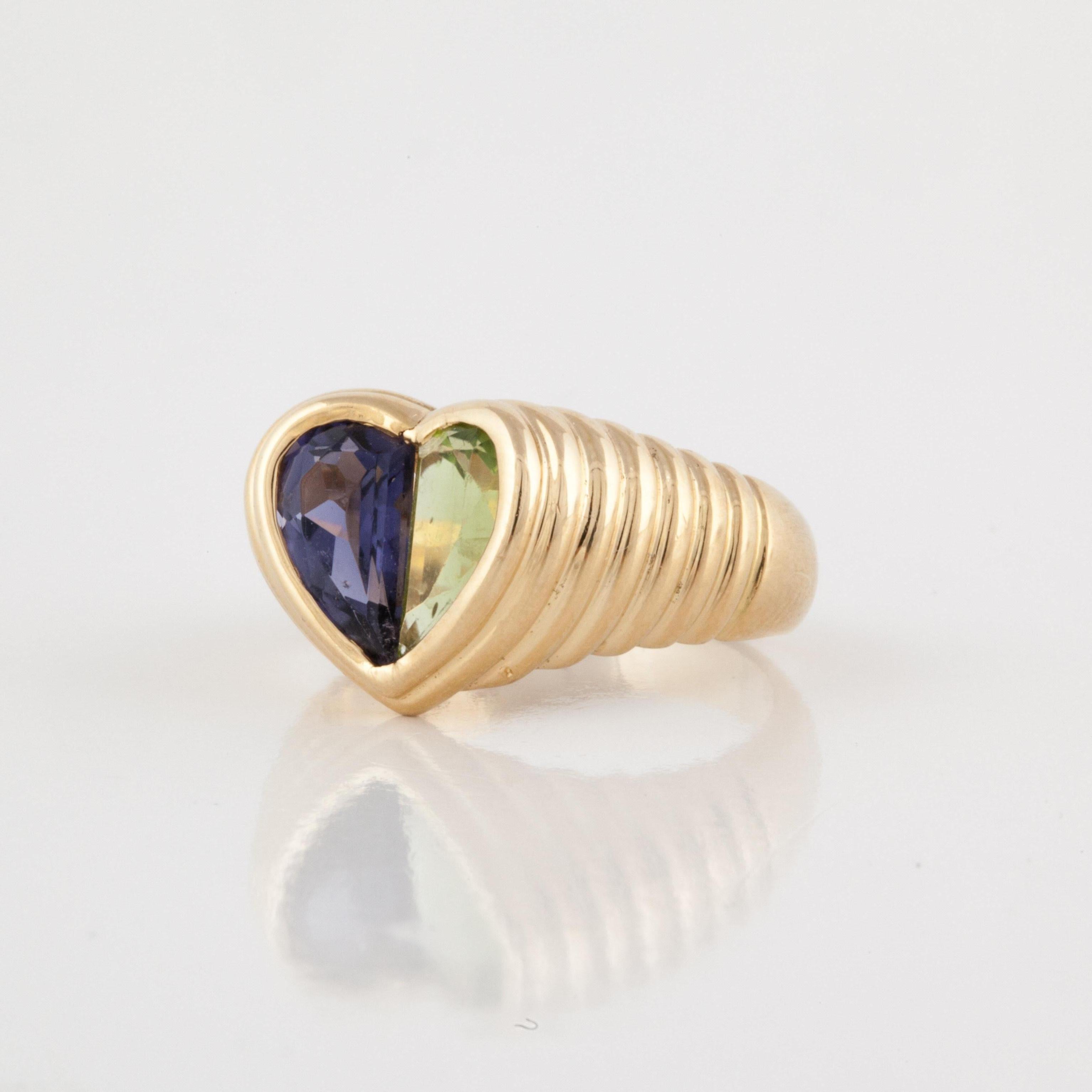 18K yellow gold ring by Bulgari.  It features a peridot and an iolite to form the heart in the center of a ridged shank.  Ring is currently a size 6.  Measures 1/2 an inch x 1/2 an inch.