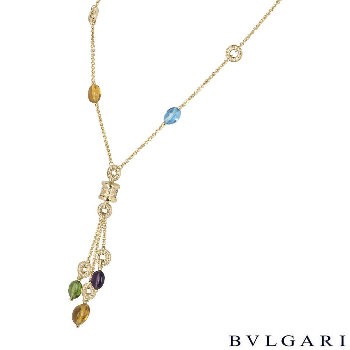 An 18k yellow gold multi-gem necklace by Bvlgari from the B.zero1 collection. The necklace comprises of a single citrine and blue topaz bead in the chain leading to the 'Bvglari Bvlgari' barrel which is partially set with round brilliant cut