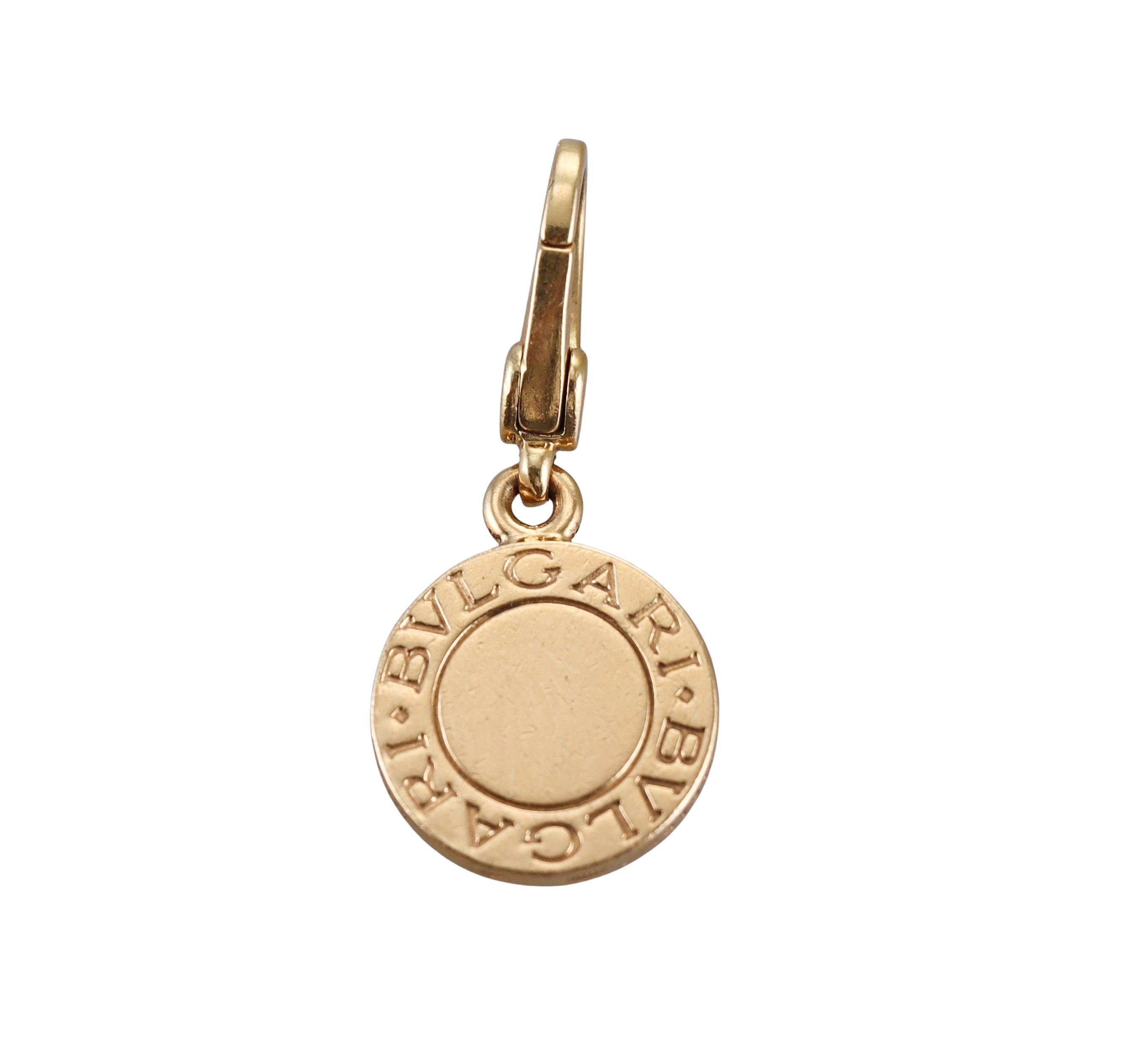 An 18k yellow gold charm pendant by Bvlgari with black onyx. Pendant is 28mm long with bale and is 13mm in diameter. Marked Bvlgari, made in Italy, 750. Weight - 3.7 grams. 