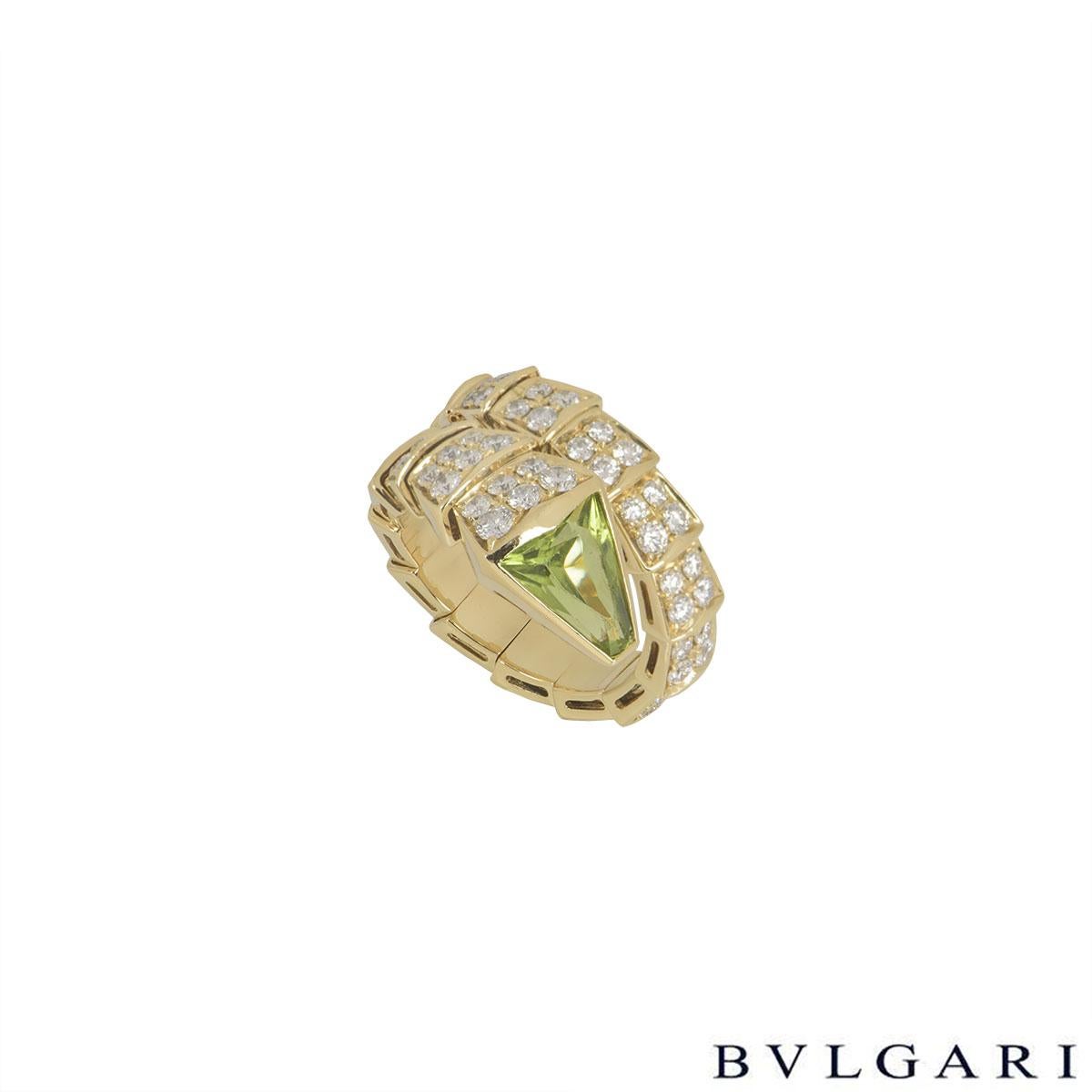 An 18k yellow gold diamond and peridot ring from the Serpenti collection by Bvlgari. The ring has 74 pave set diamonds throughout the body, totalling approximately 2.20ct, with a faceted peridot set in the head of the serpent. The ring measures