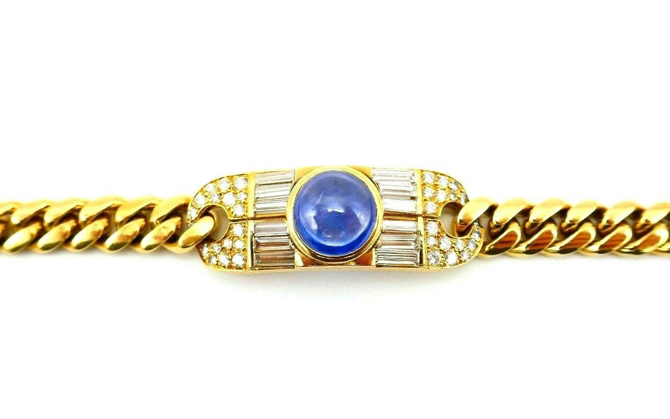 An 18 karat yellow gold, sapphire and diamond Bulgari bracelet. 
Designed as a curb link chain, centering an oval plaque, set with pave and baguette cut diamonds. A round cabochon sapphire in the center measuring approximately 10 mm. Forty (40)