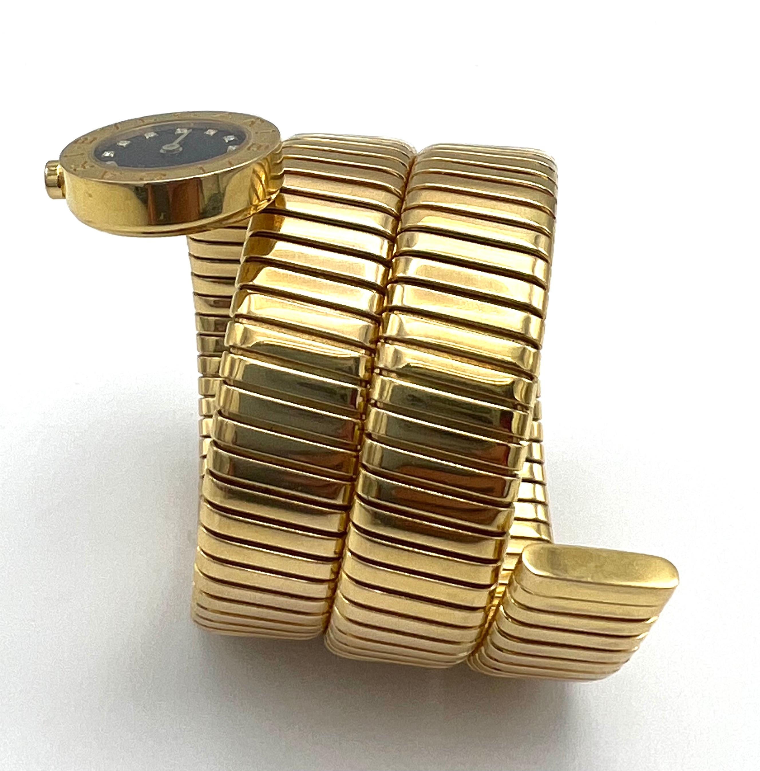 Product details:

The watch is made out of 18K yellow gold. It features black face with 12 round brilliant cut diamonds around it, quartz movement, 19mm case diameter, engraved bezel and wrap around design. The watch comes with the original fitted