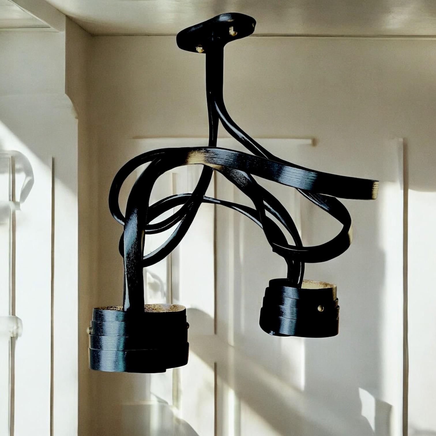 A chandelier made in solid Ashwood using wood bending techniques. The piece is a complex design, giving each angle a different look. The natural curves of the design make it best suited for both, minimal and proportionately filled spaces to