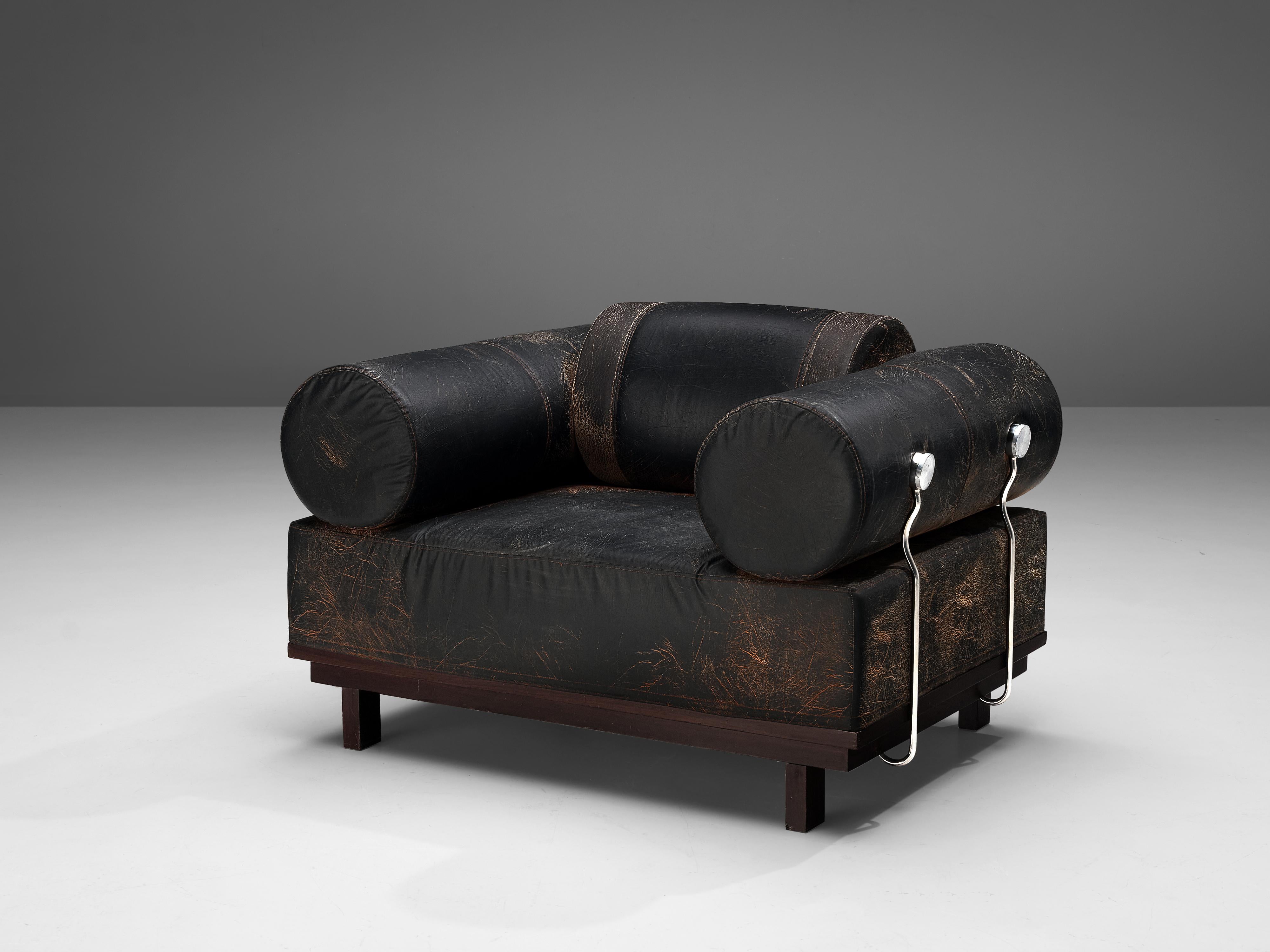 Lounge chair, leatherette, wood, metal, Europe, 1980s.

Bulky lounge chair with ottoman. The chair is characterized by multiple features that create a rather unique looking item. On the one hand side, the large size of the chair is enormous. The