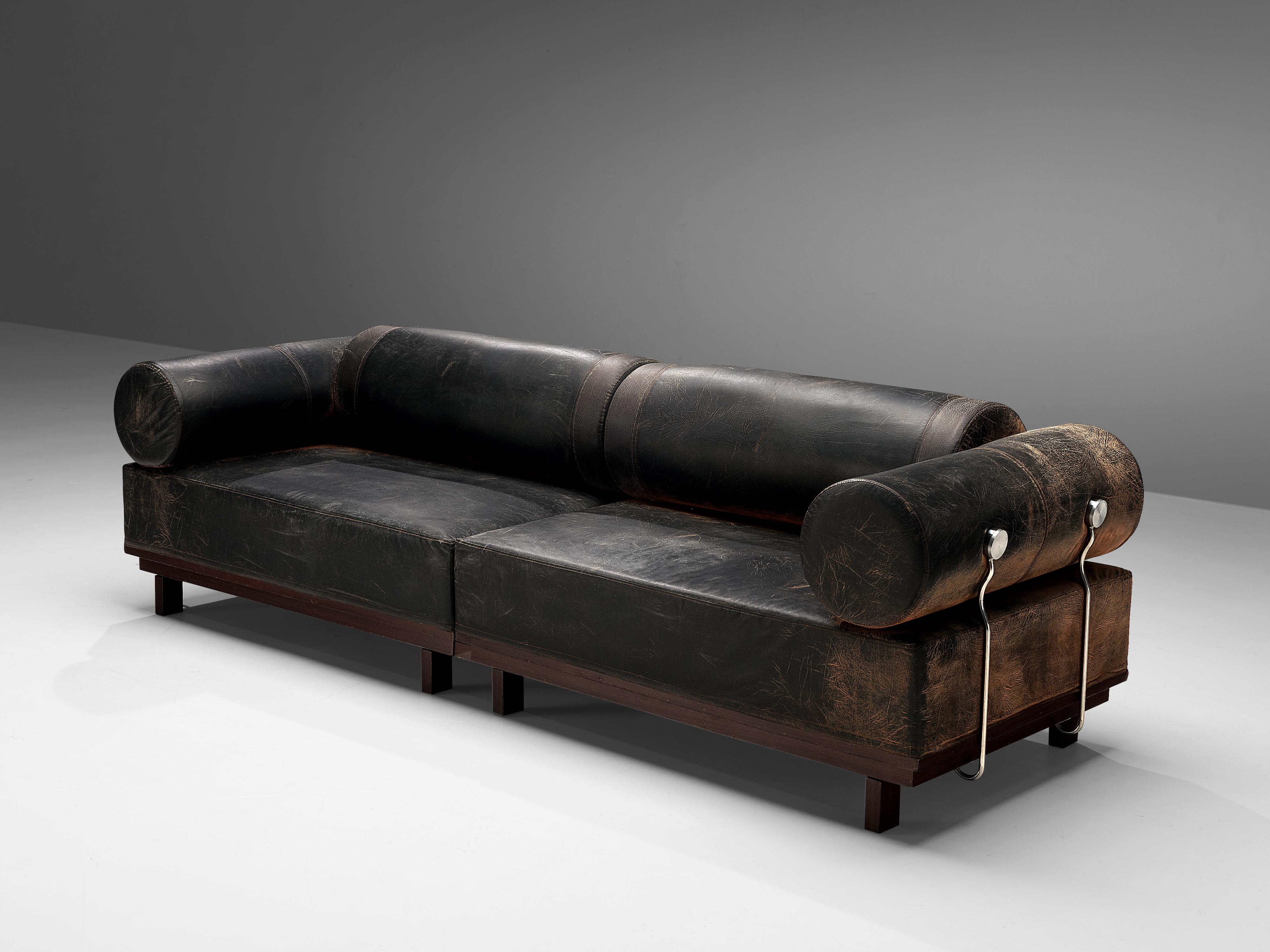 Modular sofa, leatherette, wood, metal, Europe, 1980s.

Bulky leatherette sofa with two elements. The sofa is characterized by multiple features that create a rather unique looking sofa. On the one hand side, the large size of the two elements is