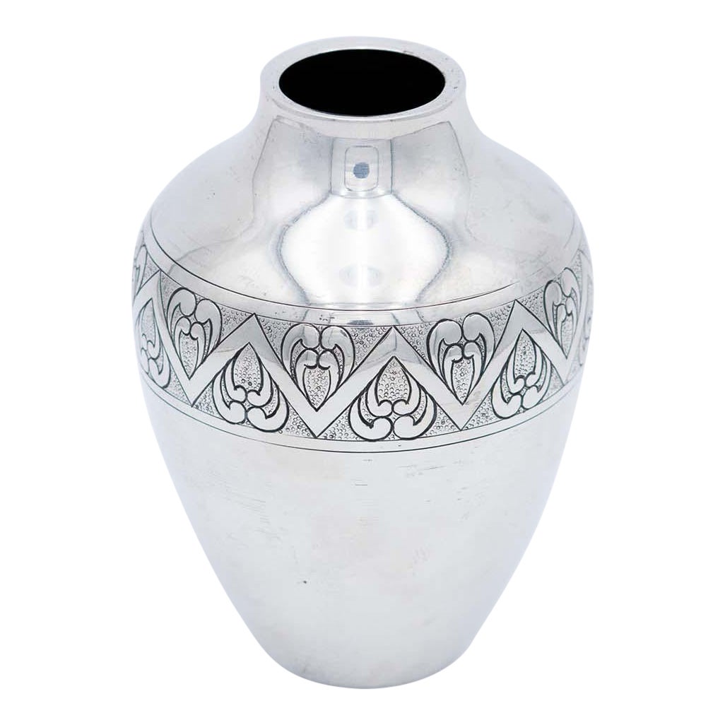 Bulky silver pot with embossed patterns