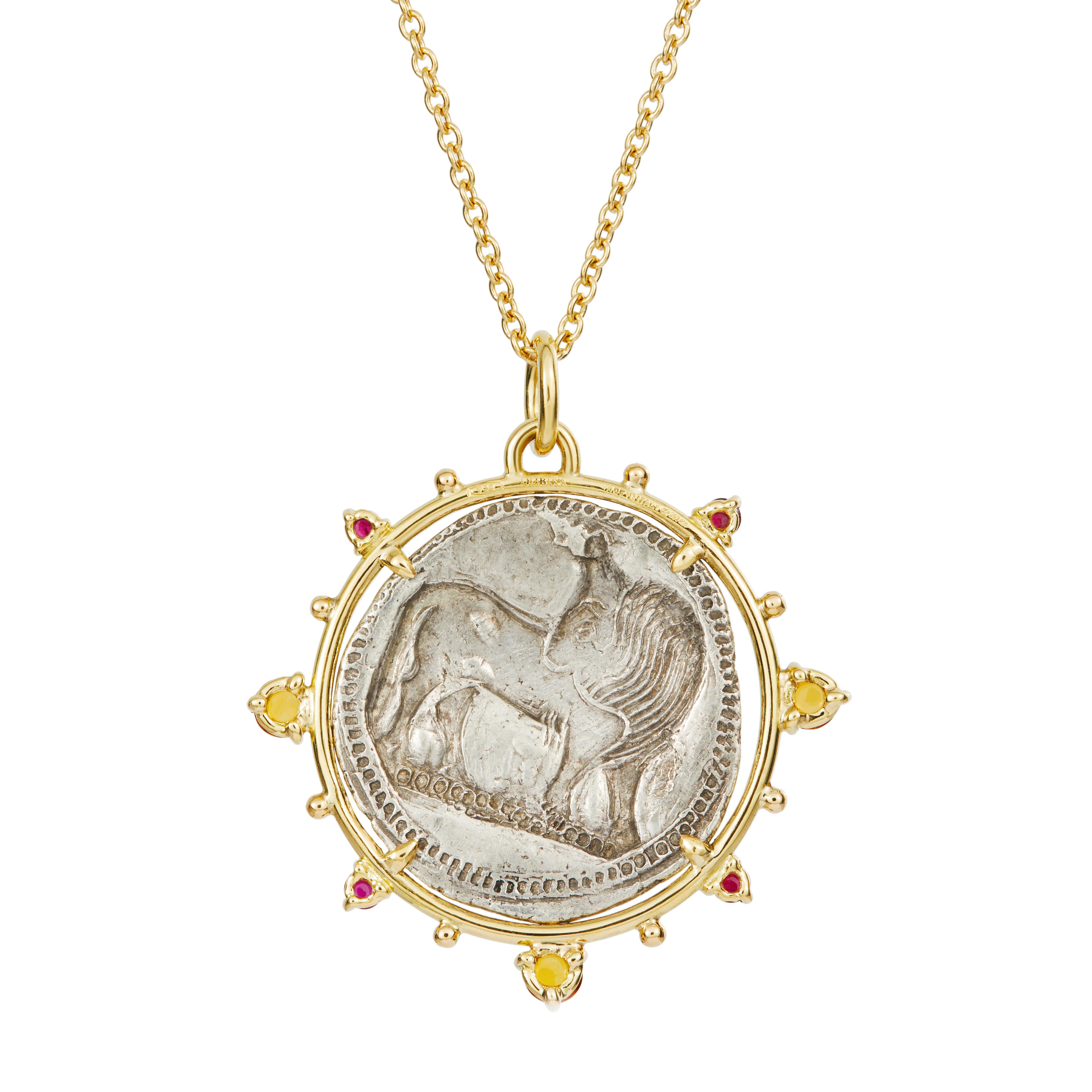 This DUBINI coin necklace from the 'Empires' collection features authentic silver coin minted in Lucania circa 530-510 B.C. set in 18K gold with ruby and citrine cabochons.

DEPICTED ON THE COIN
Obverse: Bull standing left, head right; VM in