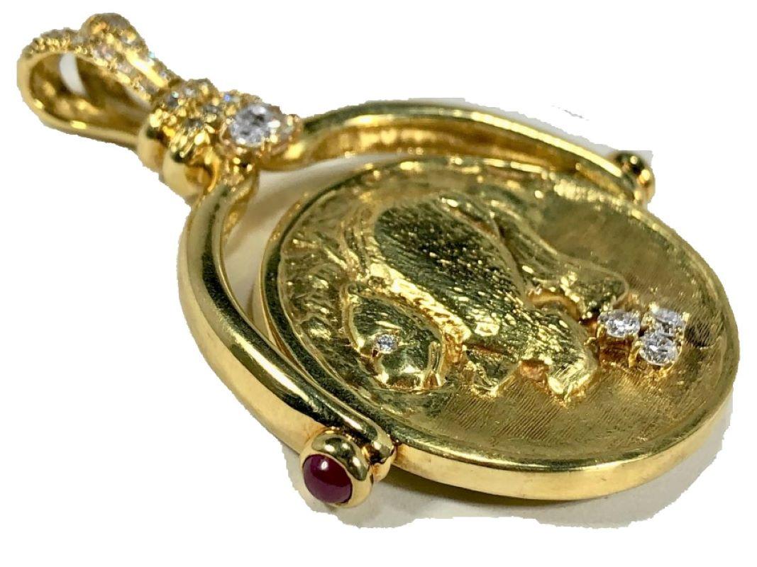 This large, very well executed and novel 18K yellow gold pendant features, at it's center, a spinning disk displaying the Bull and Bear symbols of equities markets with a lavish use of fine quality diamonds and two natural ruby cabochons. Total