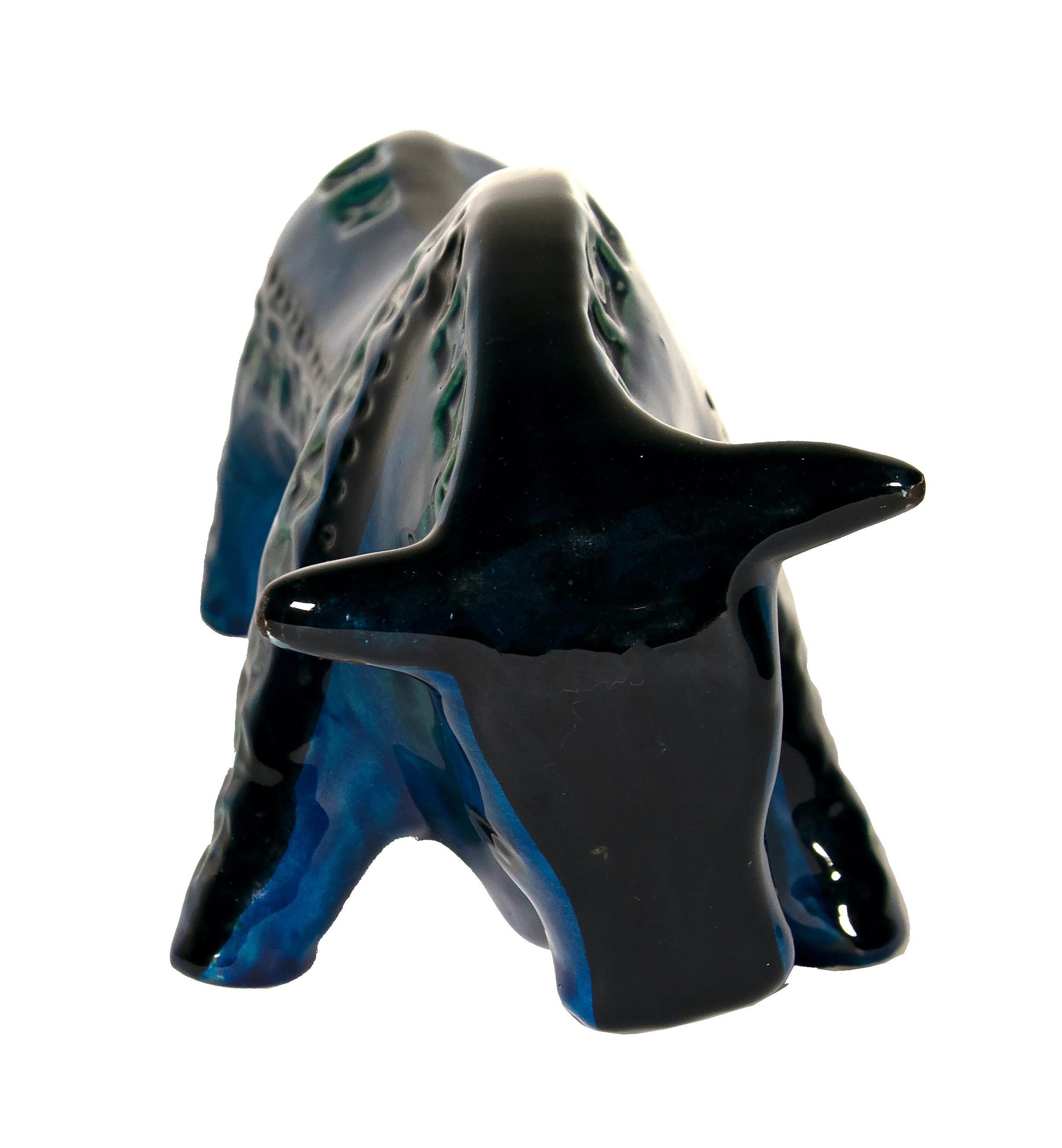 Bull from Rimini Blue series is a beautiful ceramic decorative object, realized by Aldo Londi for Bitossi in circa 1965. 

This artwork is from Rimini Blue series. Cast in white clay. Decoration engraved by hand with various patterns stencilled on
