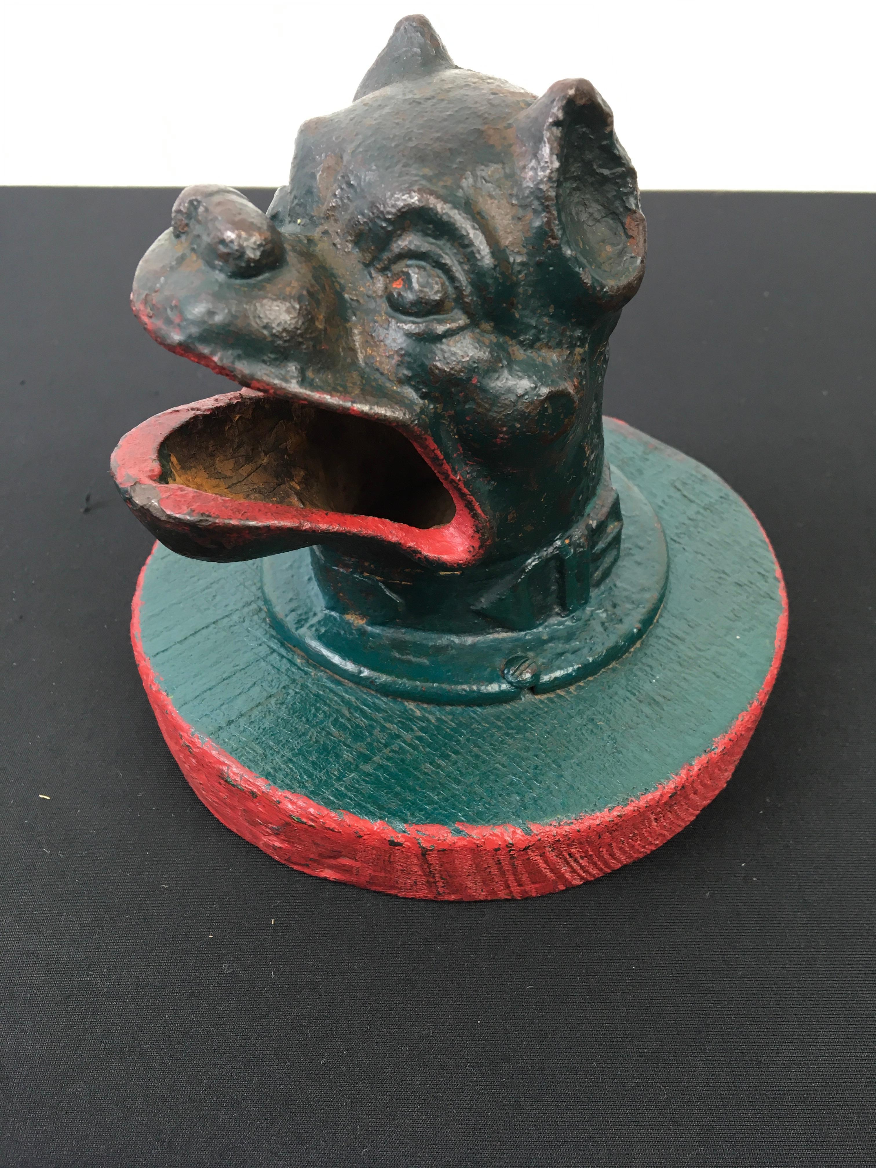 French Bulldog head from an antique coin throwing game - coin toss game.
This French antique game is known as frog game - jeu de la grenouille. 
The intention was to throw coins or jetons in the mouth of the bulldog dog.  
Most of these antique