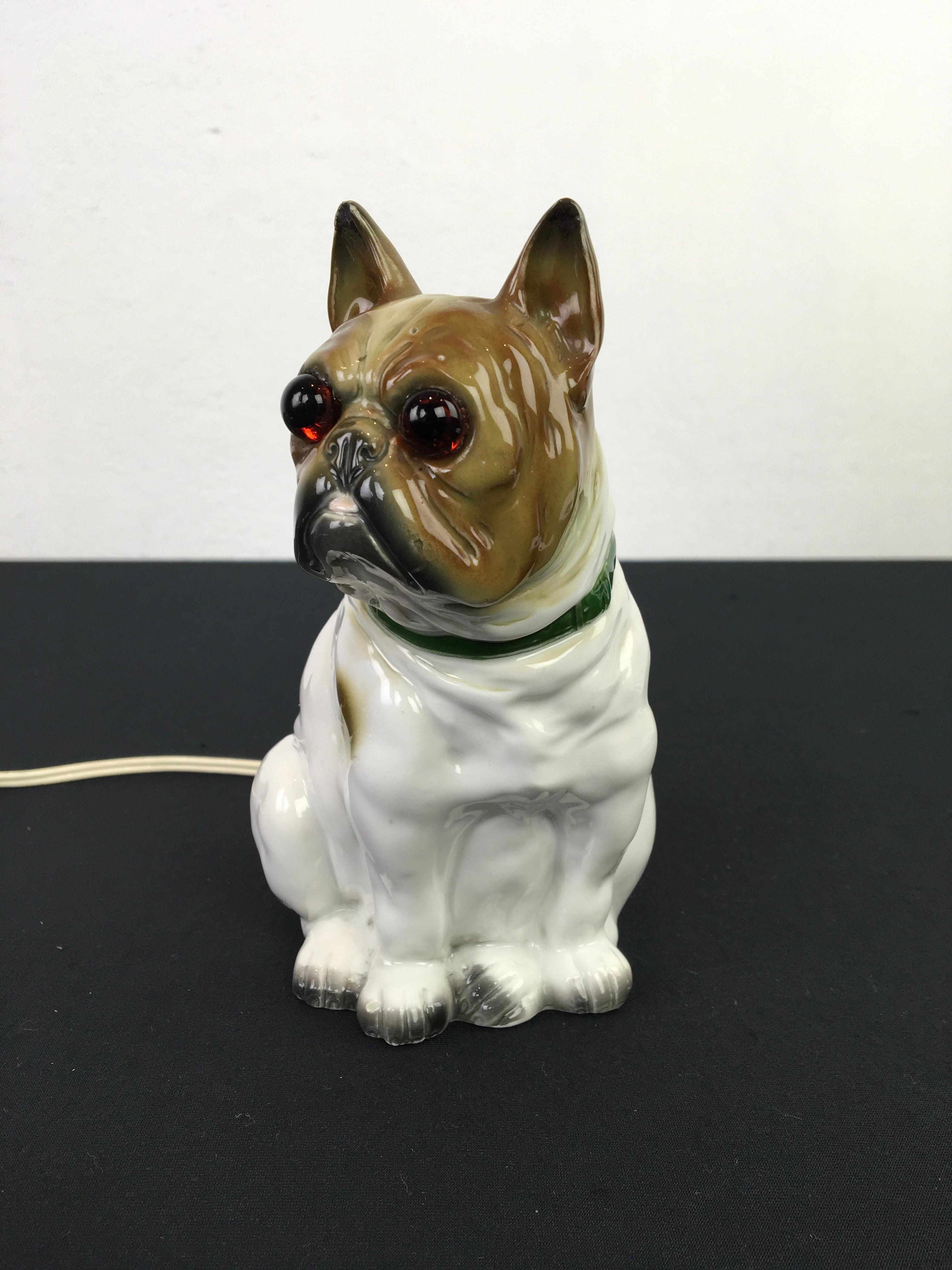 Bulldog perfume lamp - perfume light.
An Art Deco figural porcelain table lamp - night lamp in the shape of a Bulldog dog with glass eyes and a green collar around his neck. 
French Bulldog - English Bulldog. 

This bulldog light is in good