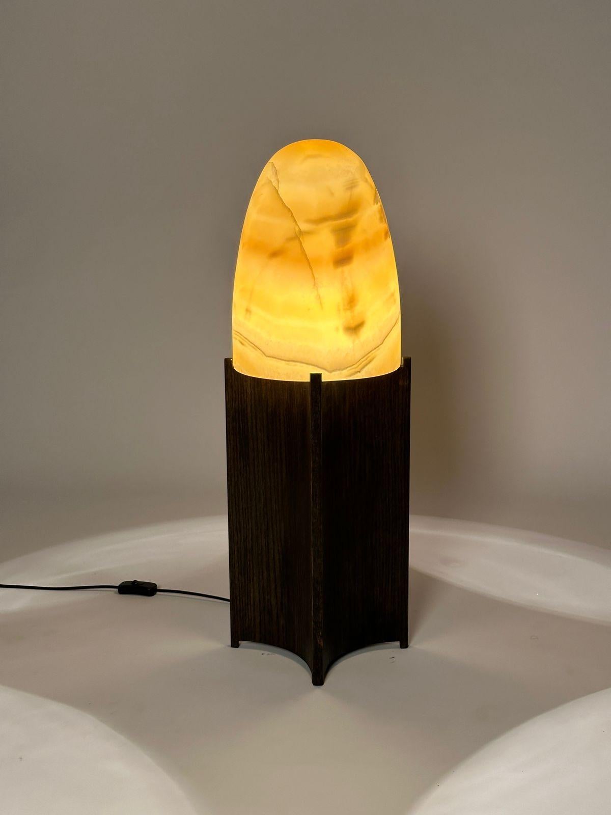 The Bullet lamp is additional design by Hassan Abouseda for HAF. 

As shown here the shade is hand carved Egyptian Alabaster. It is also available in Turkish Carrara. The base in oak veneer with custom stain and clear oil finish.

Offered in custom