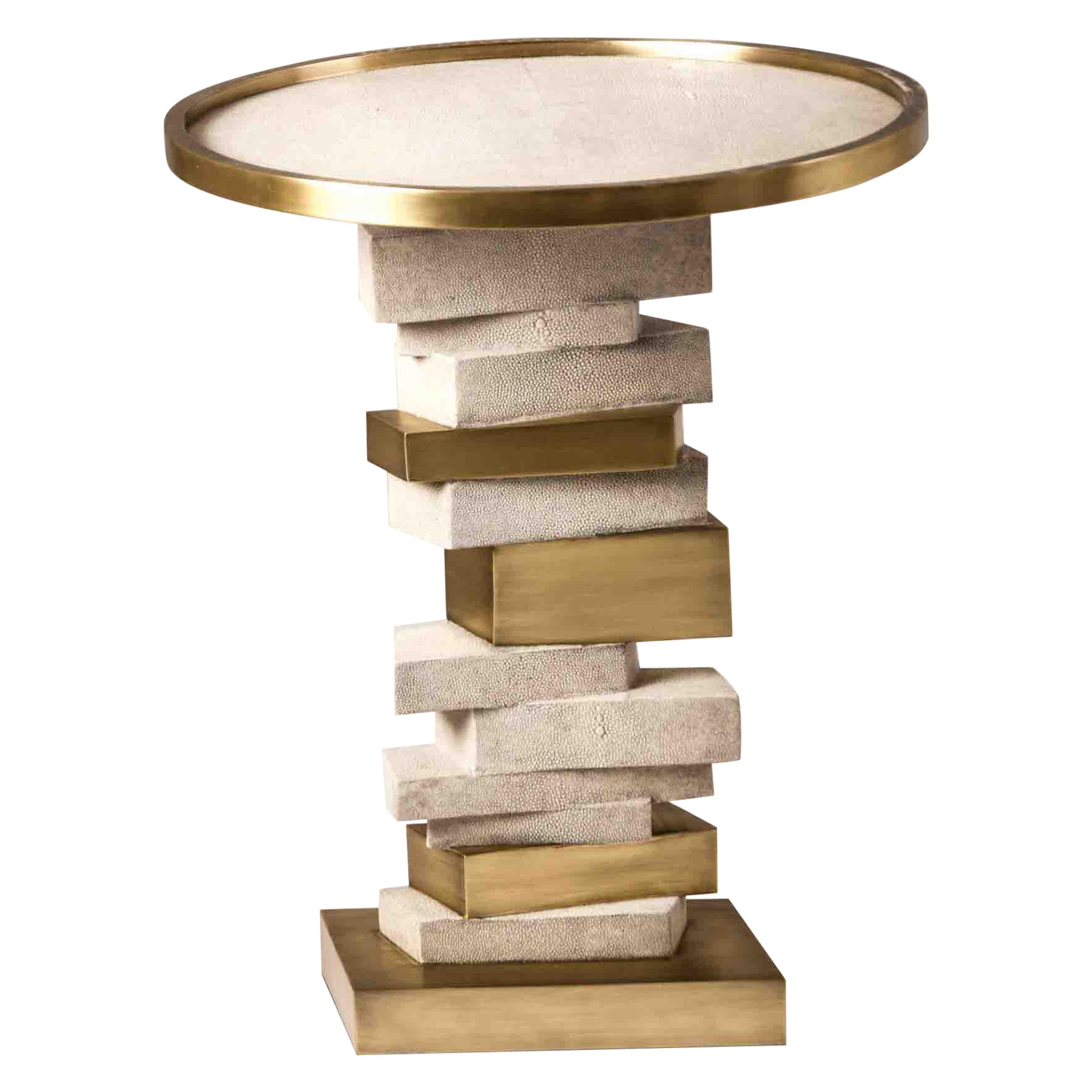 The Bullion side table is inspired by stacked gold bars. The top of the table is inlaid in black shagreen with a bronze-patina brass frame. The stacked inspired gold bars are inlaid in a mixture of shagreen and brass. This piece makes for a playful