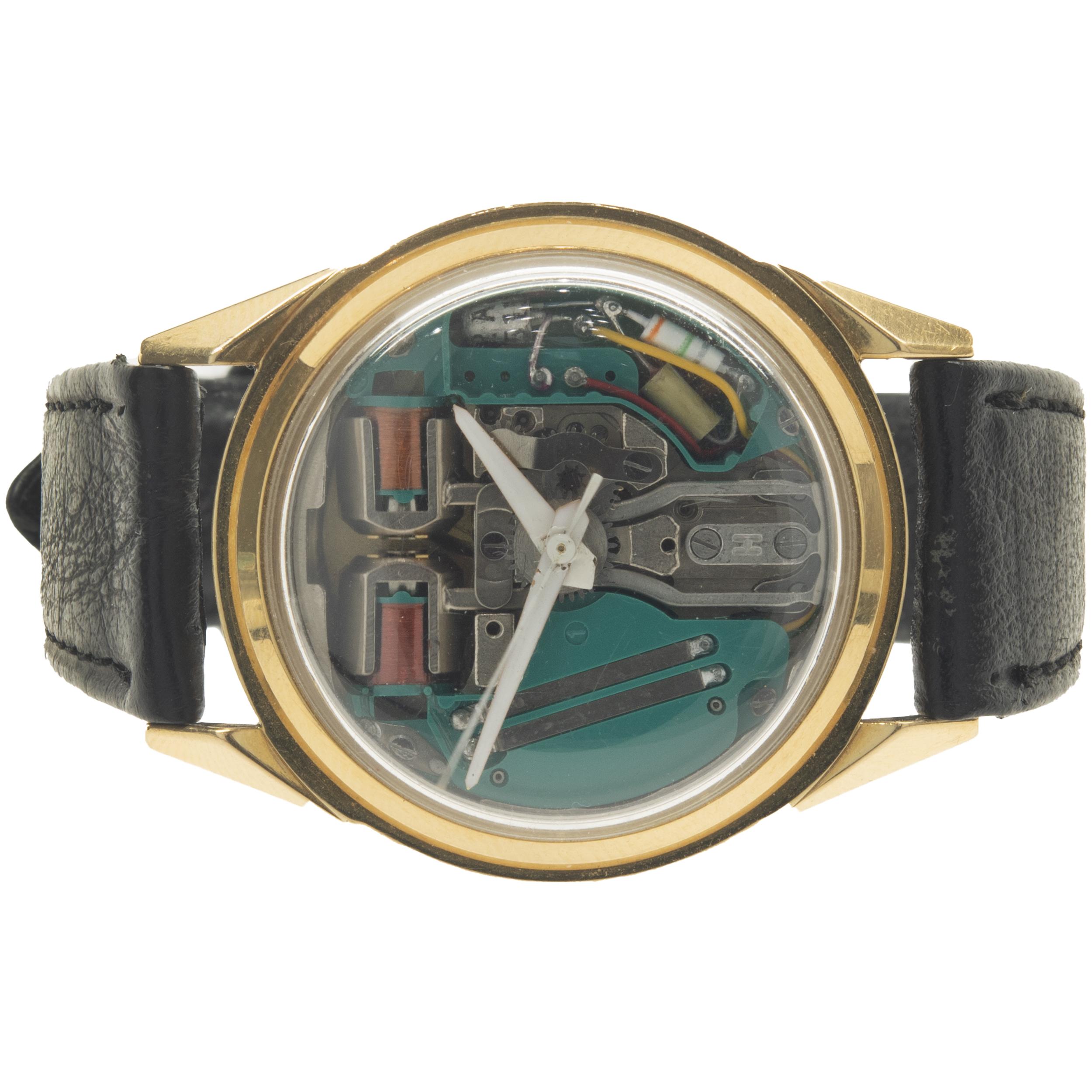 Movement: quartz
Function: hours, minutes, seconds
Case: 34mm 18k yellow gold case, plastic protective crystal
Band: black leather strap, buckle
Dial: skeleton dial
Serial: D84XXX

No box or papers included
Guaranteed to be authentic by seller.