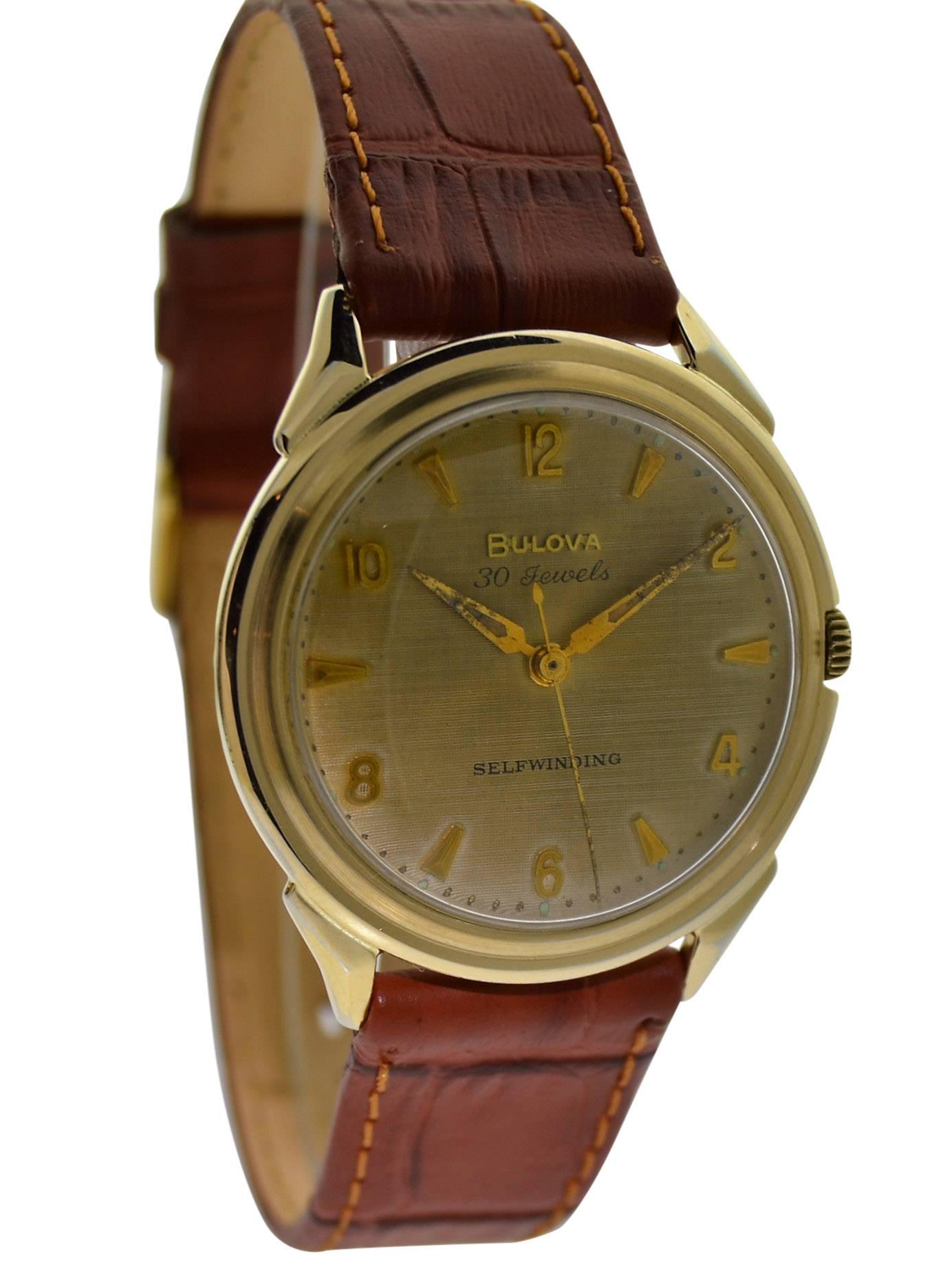 FACTORY / HOUSE: Bulova Watch Company
STYLE / REFERENCE: Round / Waterproof
METAL / MATERIAL: Yellow Gold Filled
CIRCA: 1960's
DIMENSIONS: 39mm X 35mm
MOVEMENT / CALIBER: Selfwinding / 30 Jewels 
DIAL / HANDS: Original with Gilt Finish and