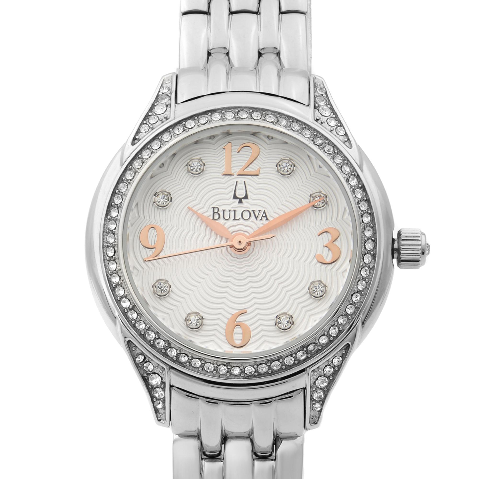 This pre-owned Bulova  96X125 Watch is a beautiful womens timepiece that is powered by quartz (battery) movement which is cased in a stainless steel case. It has a round shape face, and has hand sticks style markers. It is completed with a stainless