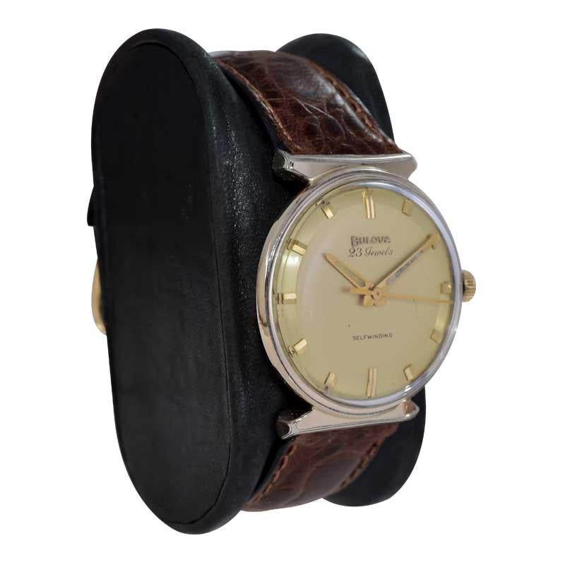 FACTORY / HOUSE: Bulova Watch Company
STYLE / REFERENCE: Mid Century Round
METAL / MATERIAL: Yellow Gold Filled
CIRCA / YEAR: 1963
DIMENSIONS / SIZE: Length 36mm X Diameter 32mm
MOVEMENT / CALIBER: Automatic Winding / 23 Jewels 
DIAL / HANDS: