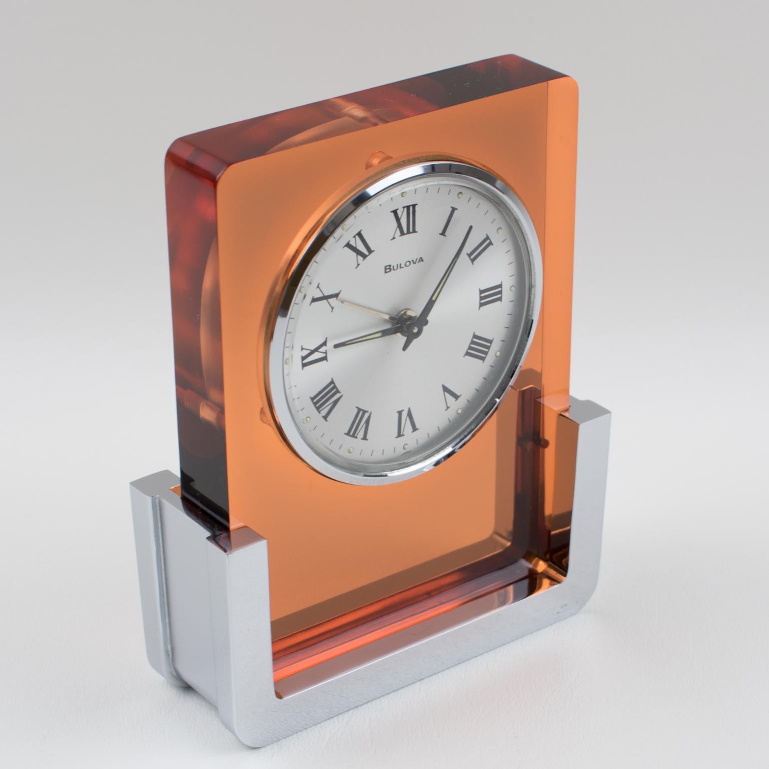 A beautiful table clock by Bulova Japan. Model 2RA007 build with transparent copper Lucite and chromed metal in a very modernist shape. This is a wind-up alarm clock, in excellent working condition, it even glows in the dark!!
Measurements: 3.94