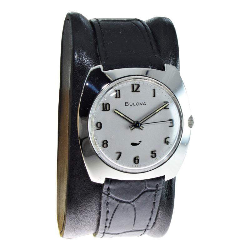 FACTORY / HOUSE: Bulova Watch Company
STYLE / REFERENCE: Moderne / Cushion Shape
METAL / MATERIAL: Stainless Steel
CIRCA / YEAR: 1960 / 70
DIMENSIONS / SIZE: Length 34mm X Width 33mm
MOVEMENT / CALIBER: Manual Winding / 17 Jewels 
DIAL / HANDS: