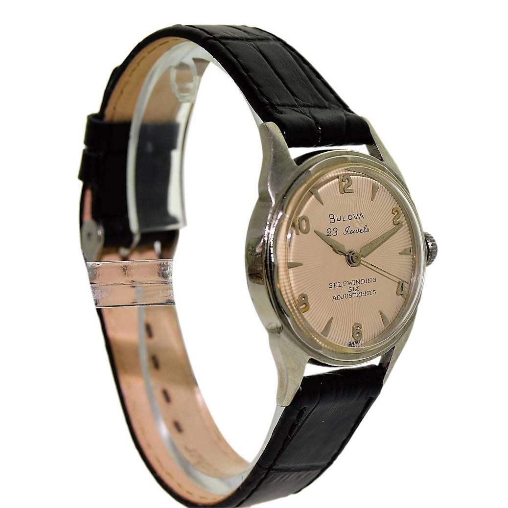 FACTORY / HOUSE: Bulova Watch Company
STYLE / REFERENCE: Round / Scalloped Bezel
METAL / MATERIAL: White Gold Filled
CIRCA: 1950's
DIMENSIONS:  38mm X 31mm
MOVEMENT / CALIBER: Automatic Winding / 23 Jewels 
DIAL / HANDS: Original Silvered Applied