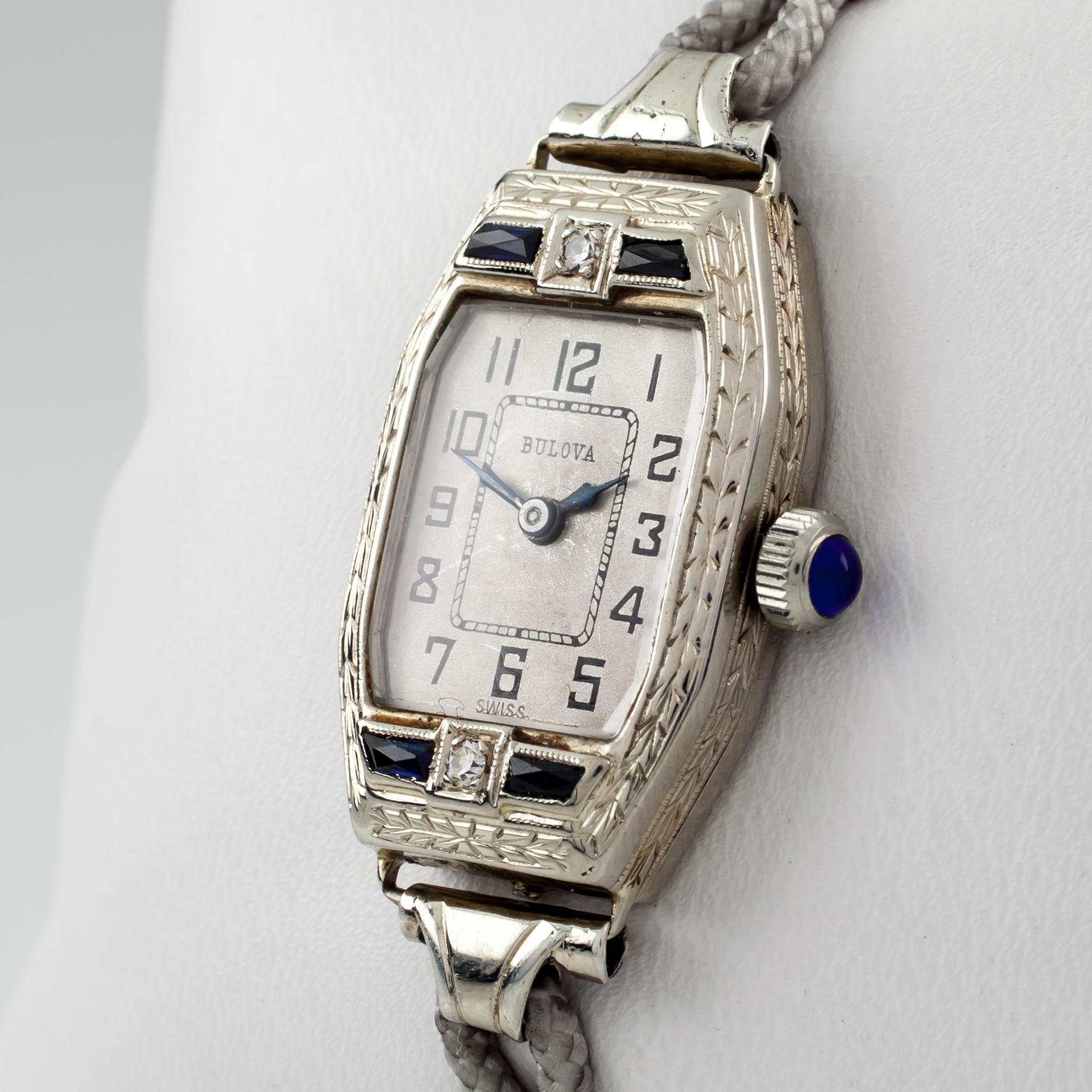 Bulova Women's Vintage 14k White Gold Hand-Winding Watch w/ Gray Cord Band
Movement #6:TA-41988

14k White Gold Case w/ Sapphire and Diamond Accents
17 mm Wide (20 mm w/ Sapphire Cabochon Crown)
26 mm Long
Lug-to-Lug Distance = 36 mm
Thickness = 6