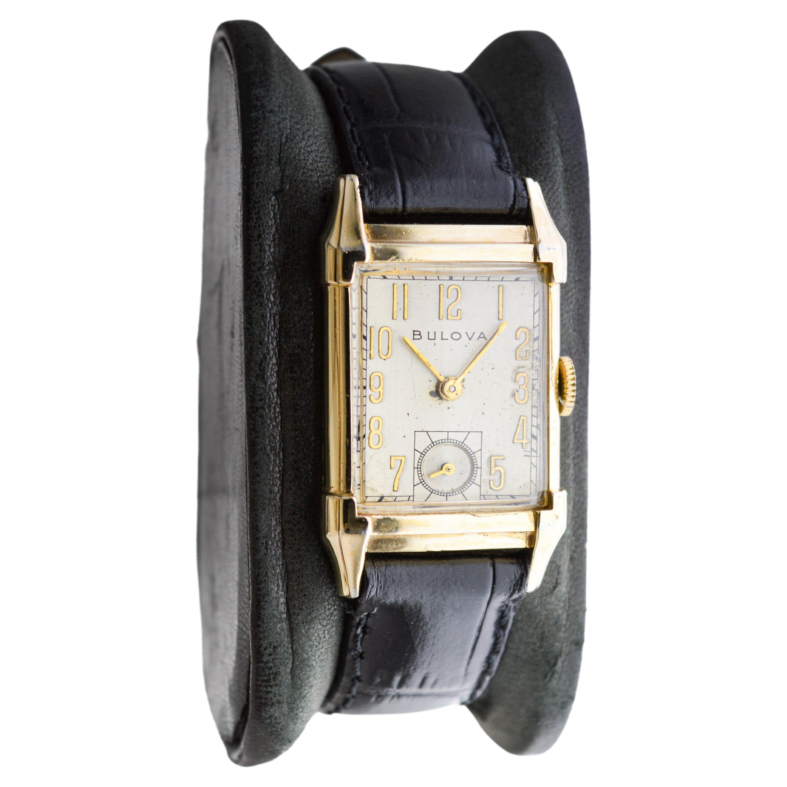 FACTORY / HOUSE: Bulova Watch Company
STYLE / REFERENCE: Art Deco / Tank Style 
METAL / MATERIAL: Yellow Gold Filled
CIRCA / YEAR: 1950's
DIMENSIONS / SIZE: Length 32mm X Width 21mm
MOVEMENT / CALIBER: Manual Winding / 21 Jewels / Caliber 7AK
DIAL /