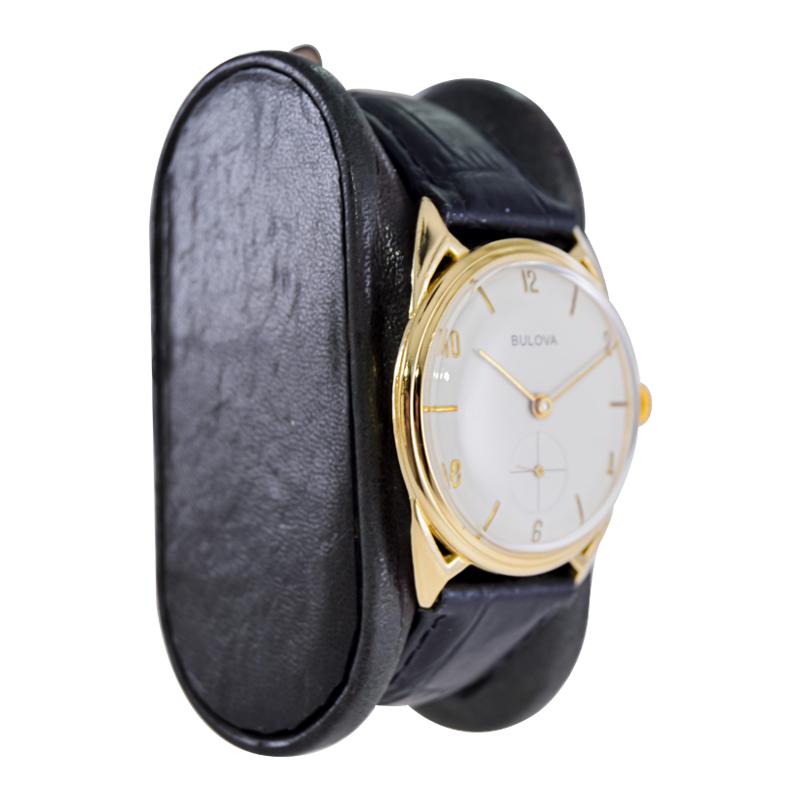 FACTORY / HOUSE: Bulova Watch Company
STYLE / REFERENCE: Art Deco / Mid Century
METAL / MATERIAL: Yellow Gold Filled
CIRCA / YEAR: 1950's
DIMENSIONS / SIZE: 40mm Length X 32mm Diameter
MOVEMENT / CALIBER: Manual Winding / 17 Jewels 
DIAL / HANDS: