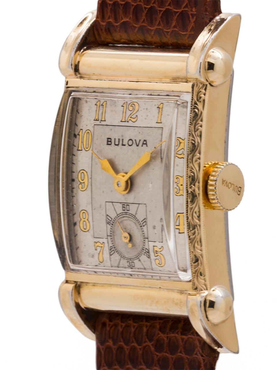 
Vintage man’s medium size Bulova YGF manual wind dress model circa 1949. Featuring a 21 X 37mm rectangular case with decorative engraved gold filled bezel and horned lugs, domed acrylic crystal, and pleasing original matte silvered dial with gold
