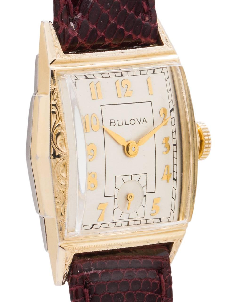 
Vintage man’s medium size Bulova YGF manual wind dress model circa 1951. Featuring a 25 X 35mm tonneau shaped case with decorative engraved bezel and lugs, domed acrylic crystal, and pleasing original matte silvered dial with gold raised indexes