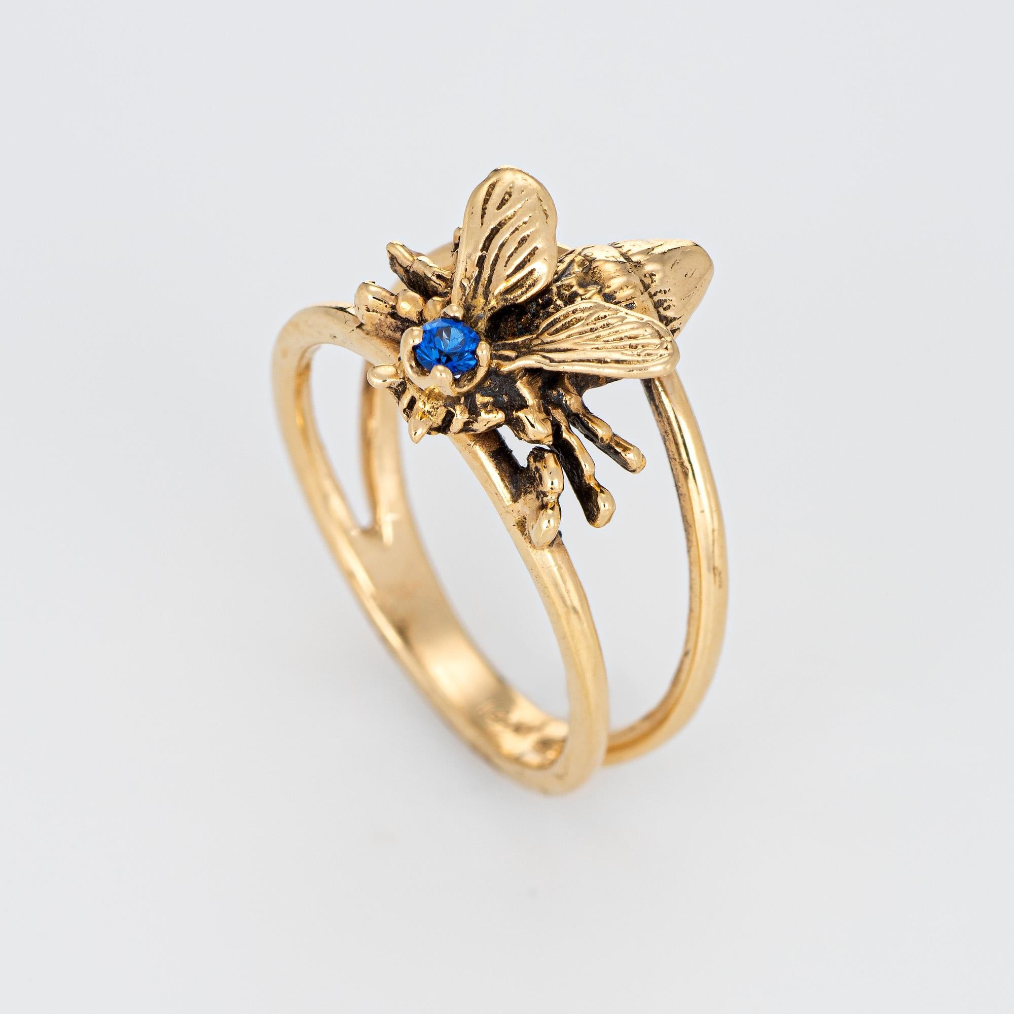 Stylish vintage bumble bee crafted in 14 karat yellow gold. 

One estimated 0.05 carat sapphire is set into the mount. The sapphire is in excellent condition and free of cracks or chips. 

The nicely detailed bee features lifelike detail to the