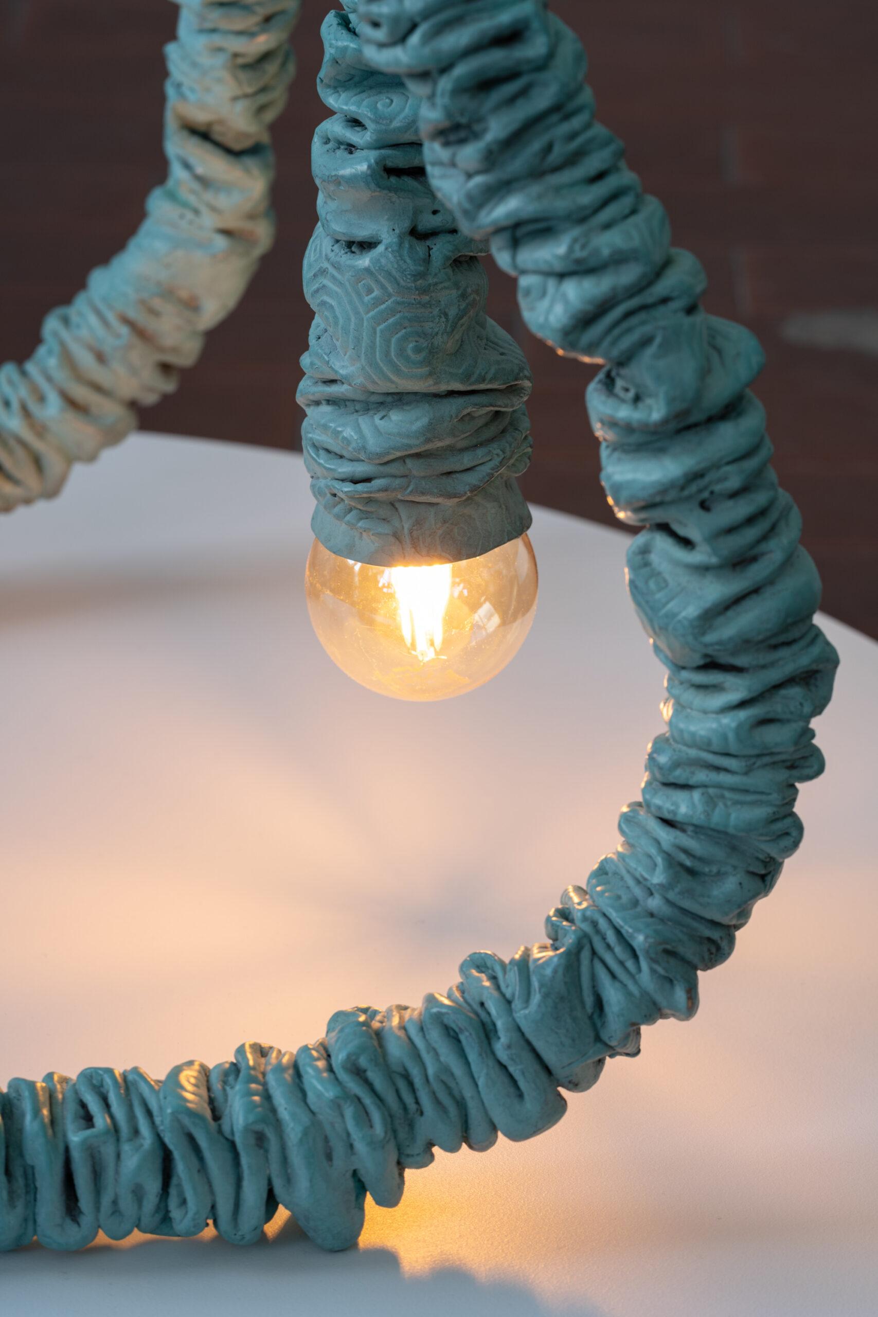 The two luminaires Bump the Lamp of Nicolas Momein, one to be placed on the floor and the other on a piece of furniture, echo his tubular metal sculptures sewn by “Bulgomme”. The “Bulgomme” fabric (evocation of his childhood), generally used as a