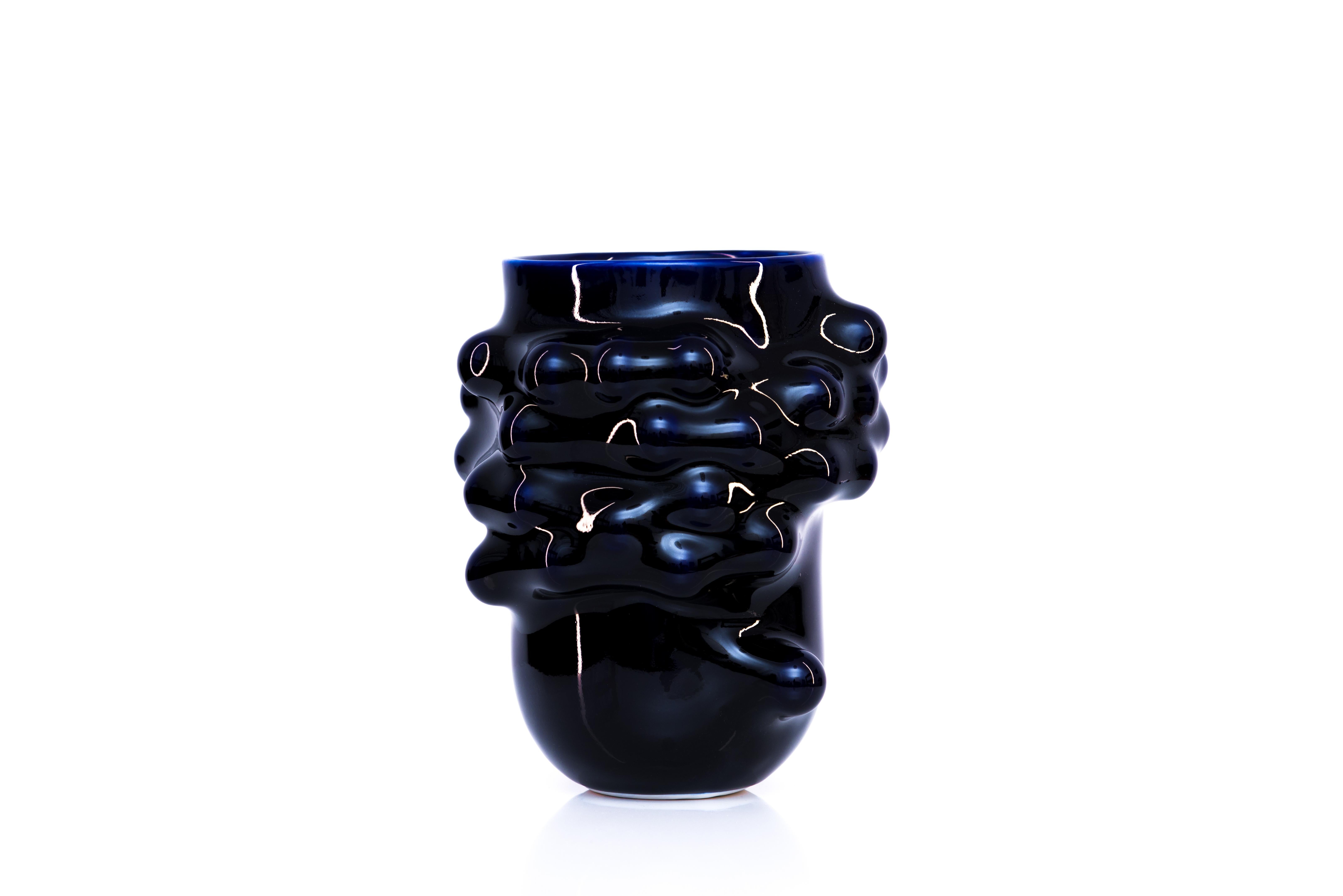 Bumps 2.0 blue cobalt vase by Arkadiusz Szwed
Dimensions: L 16 x W 16 x H 20 cm
Materials: Porcelain

Arkadiusz Szwed designs and produce ceramic products.
He lives in Warsaw / Poland and work at the School of Form as an Instructor and Head of