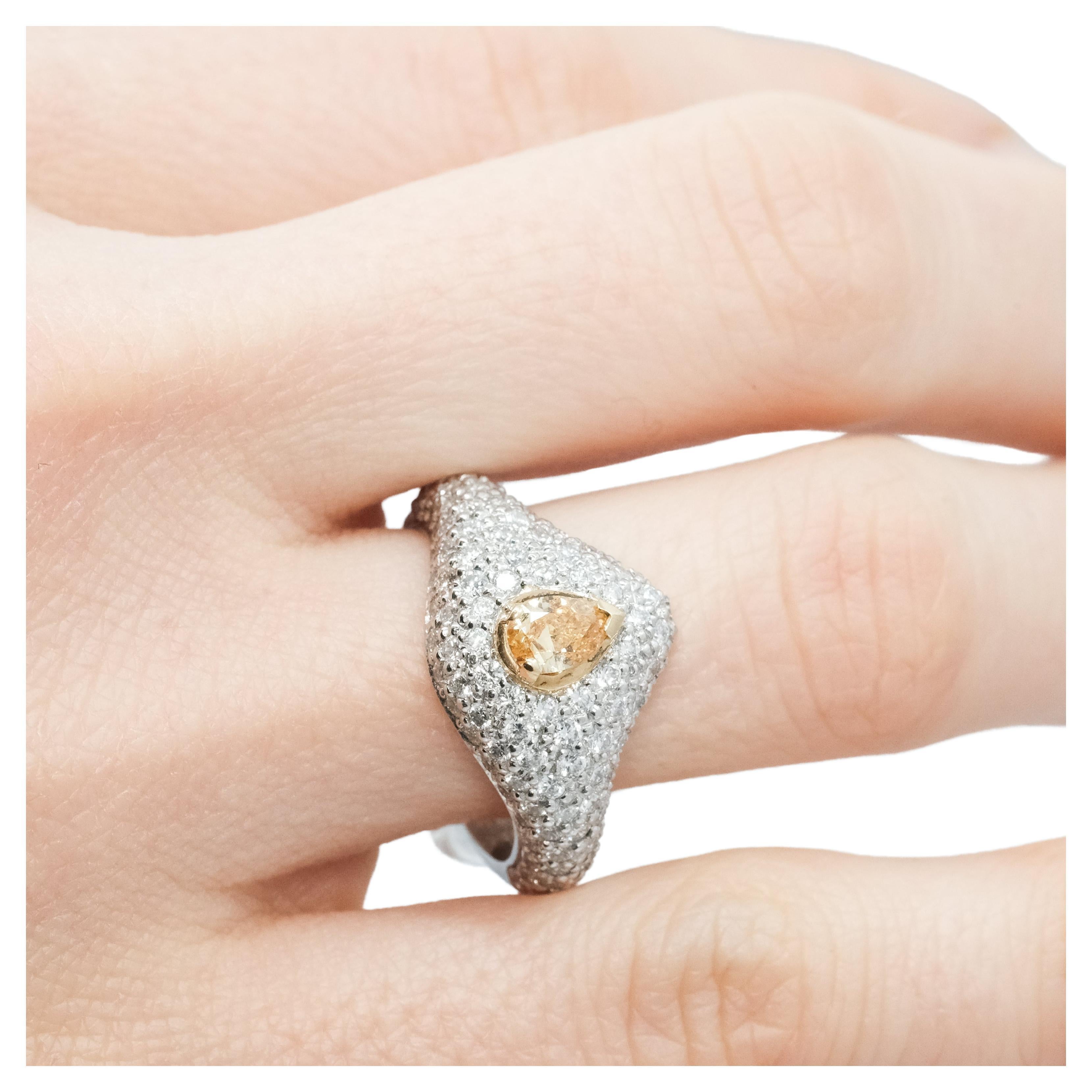 A BUNDA 'Bomb' diamond ring, featuring a yellow, pear-shaped diamond, claw set in 18ct yellow gold to the centre, surrounded with pave set, white round brilliant cut diamonds in platinum.

Characteristics of pear shape diamond: 1 = 0.36ct, Fancy